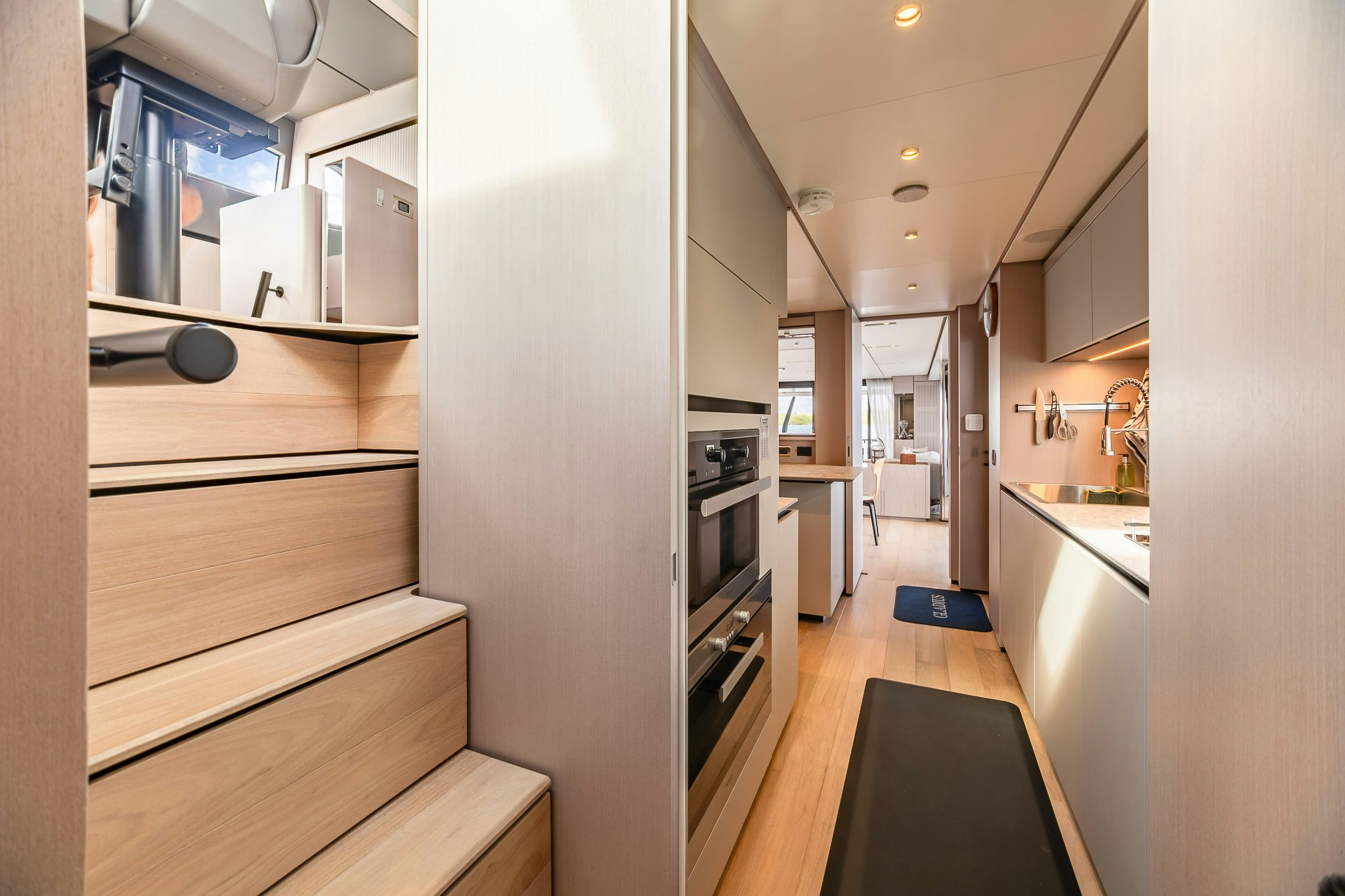 a kitchen with a wood floor aboard AURORA Yacht for Sale