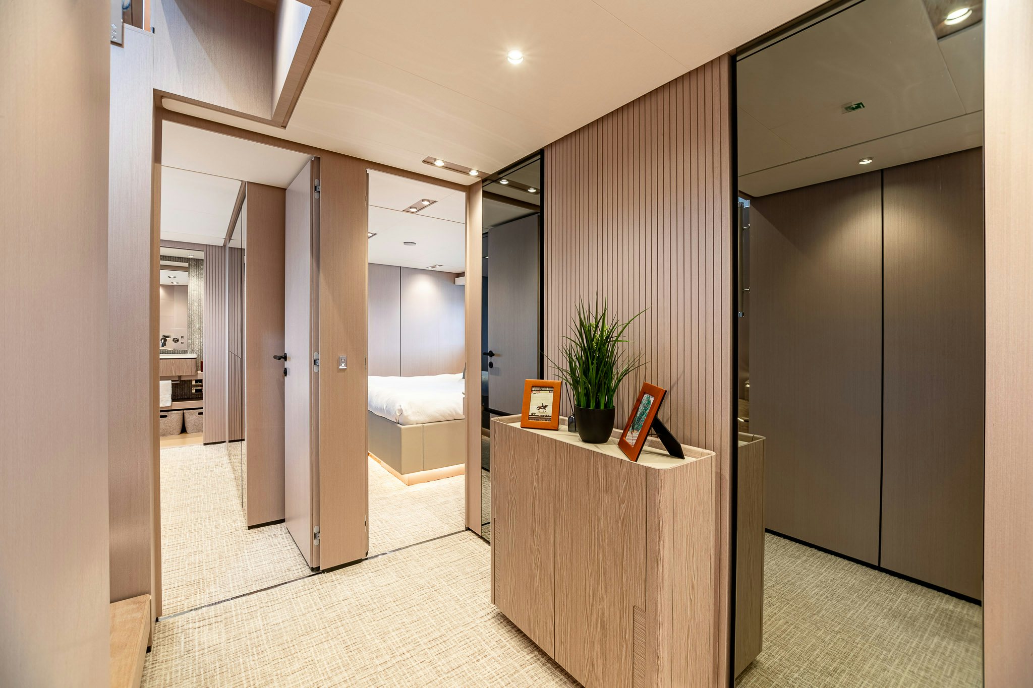 a room with a large mirror and a counter with a plant on it aboard AURORA Yacht for Sale