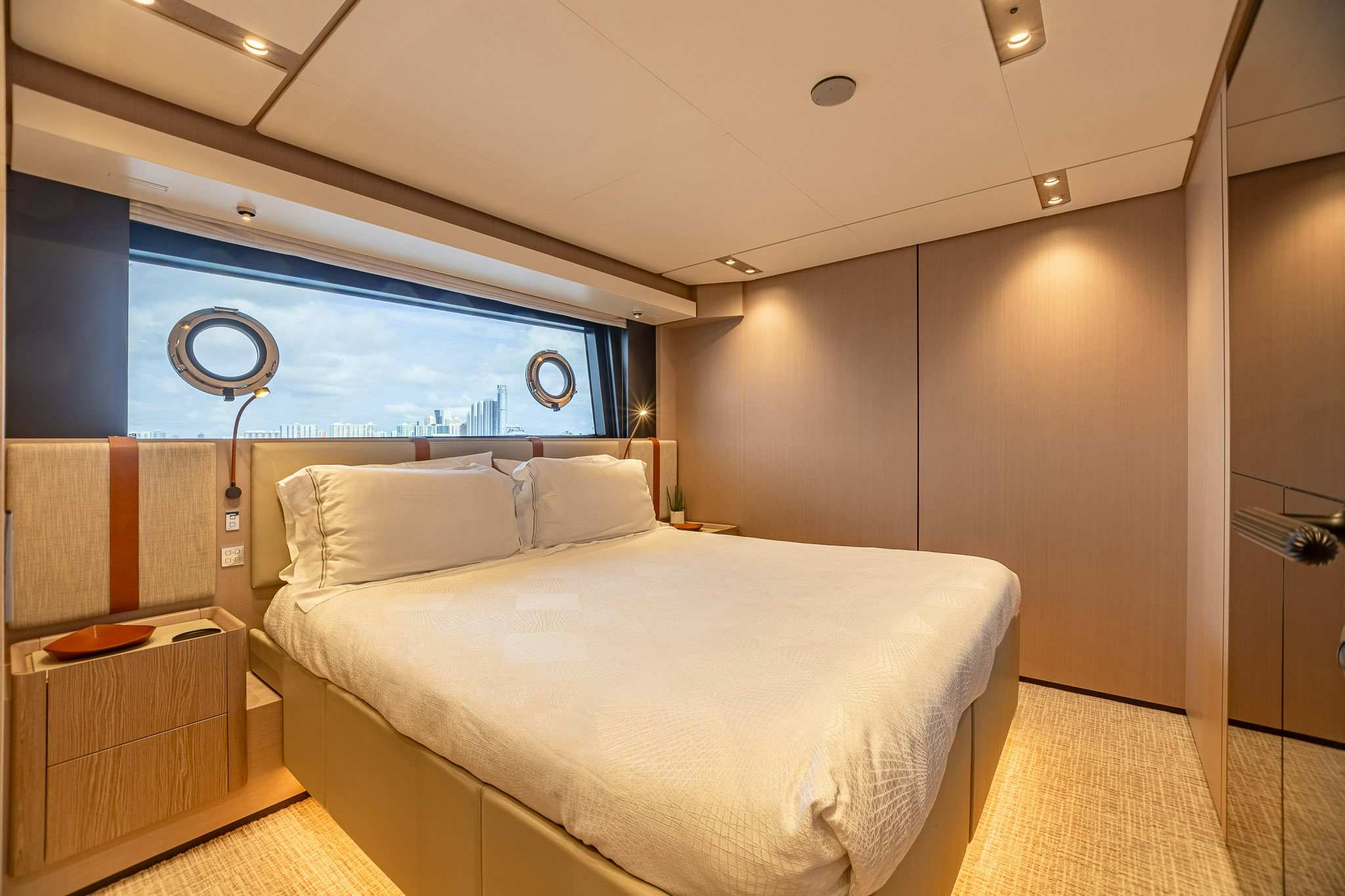 a room with a bed and a desk aboard AURORA Yacht for Sale
