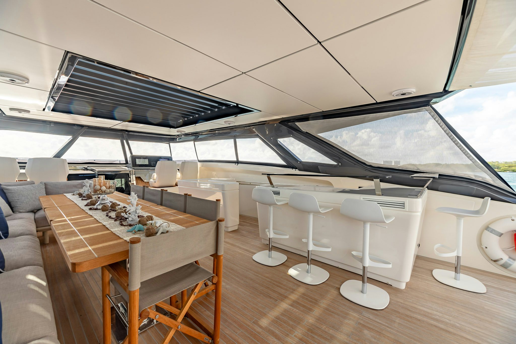 a room with a table chairs and a large window aboard AURORA Yacht for Sale