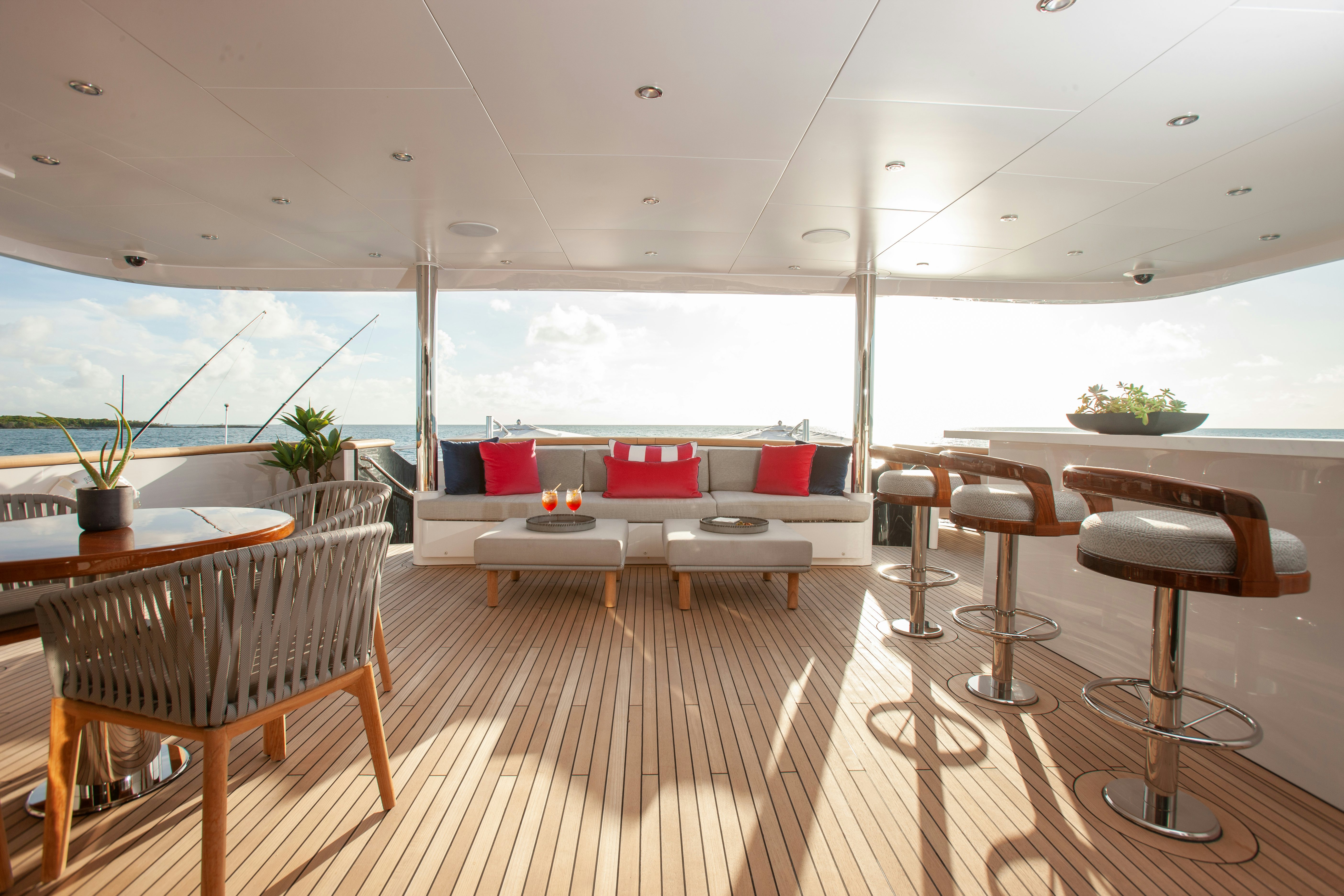 a room with tables and chairs aboard NO BAD IDEAS Yacht for Sale