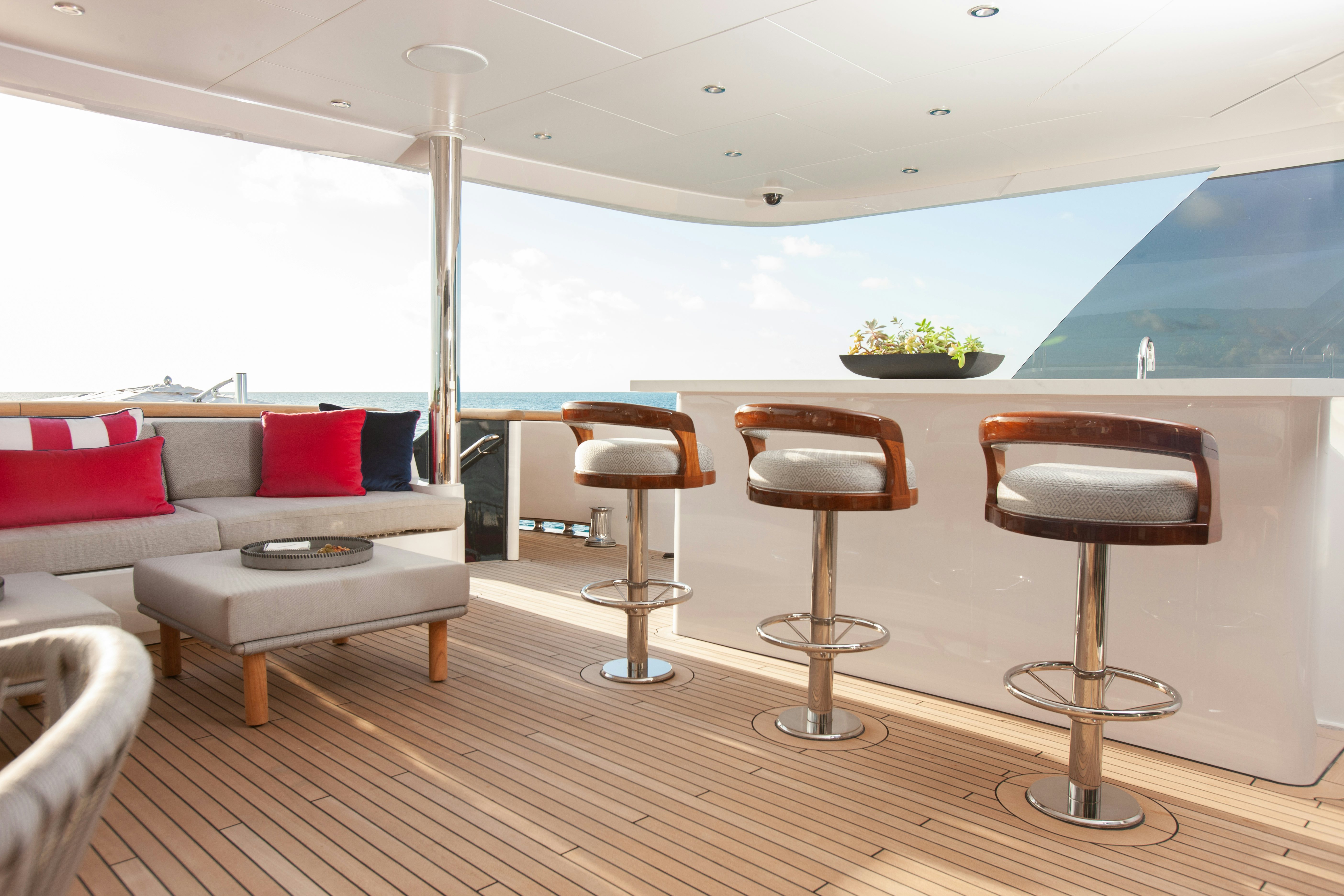 a room with a couch and a table and chairs aboard NO BAD IDEAS Yacht for Sale