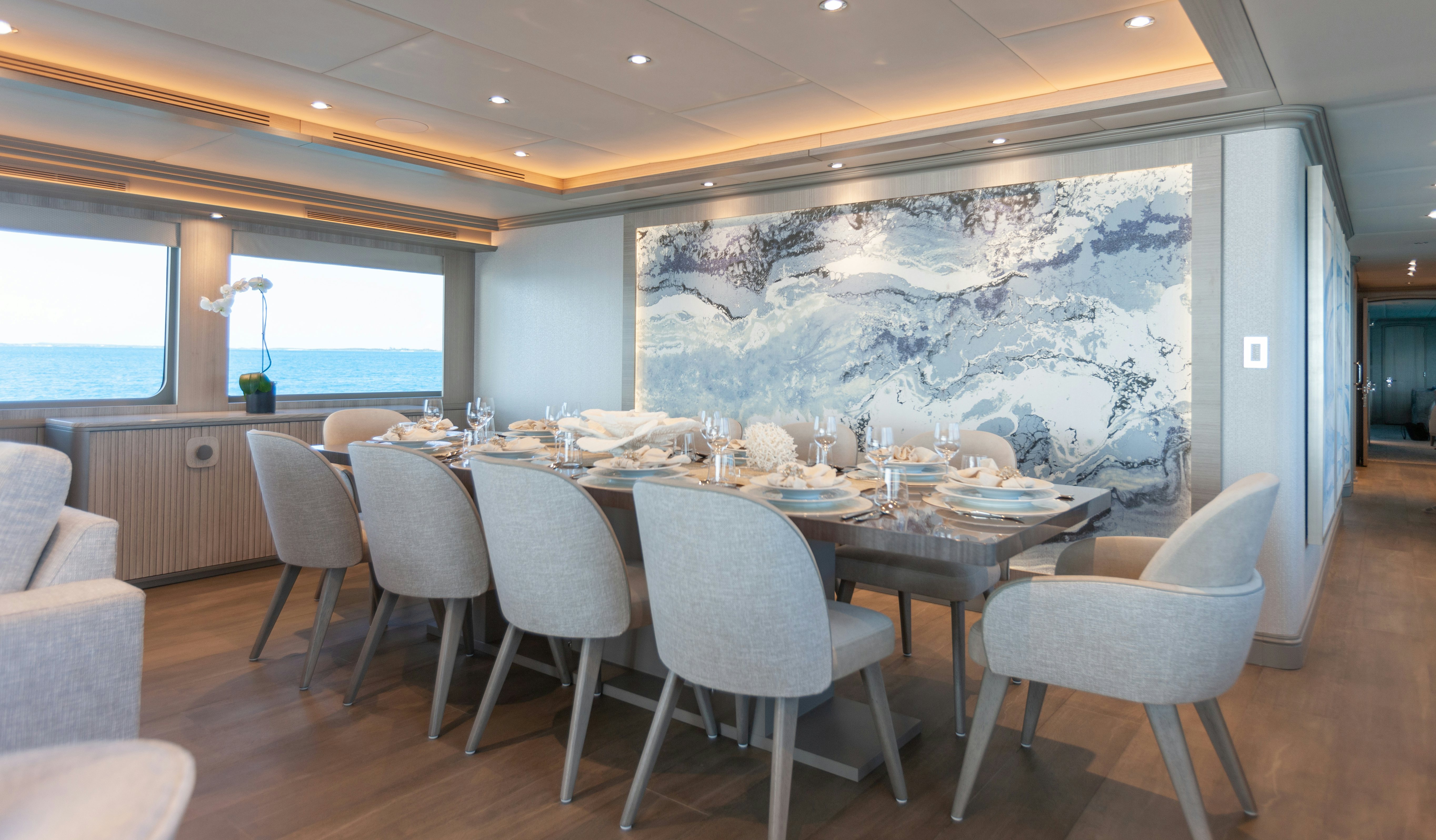 a large dining table with chairs around it aboard NO BAD IDEAS Yacht for Sale