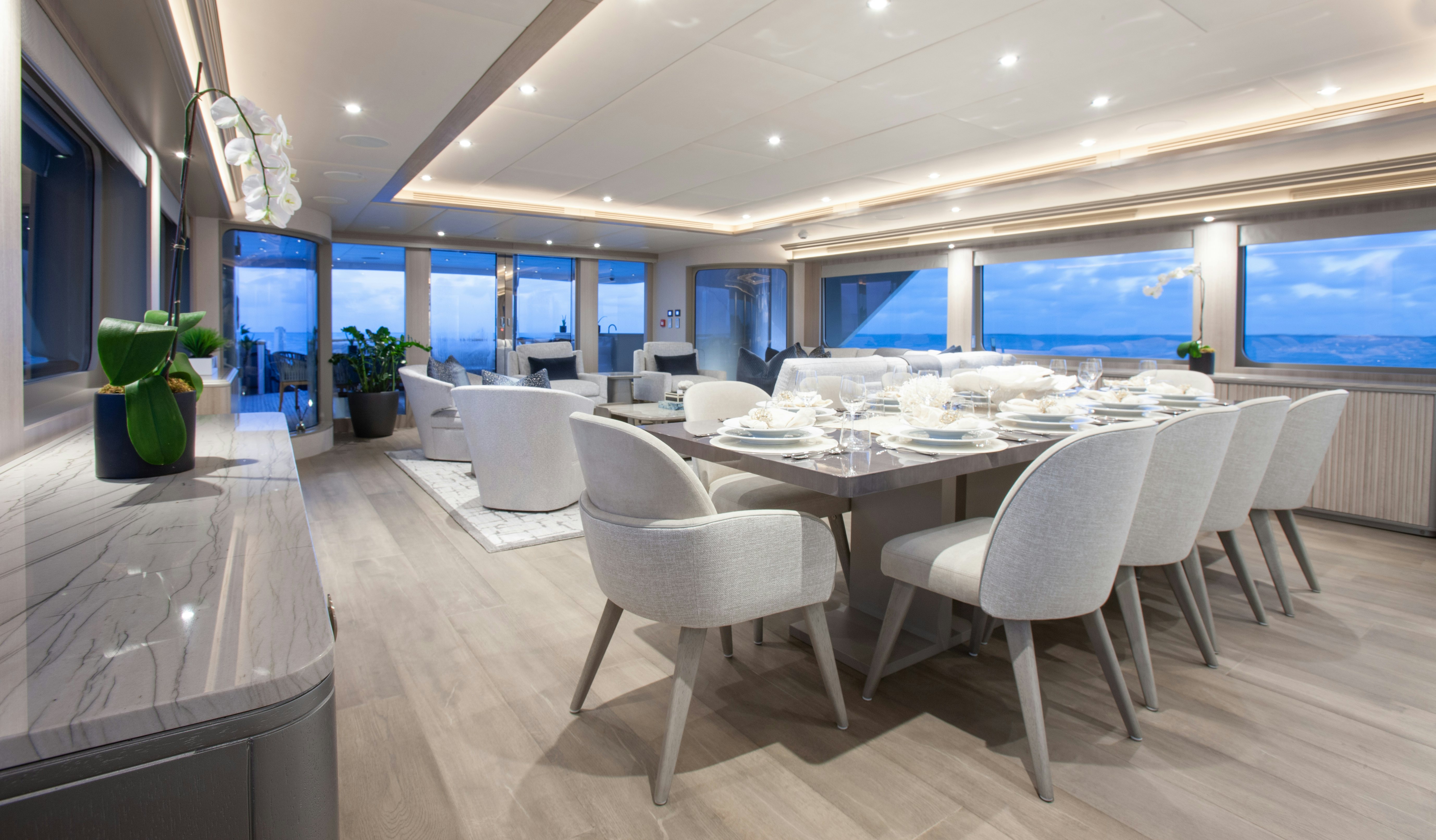 a large room with tables and chairs aboard NO BAD IDEAS Yacht for Sale