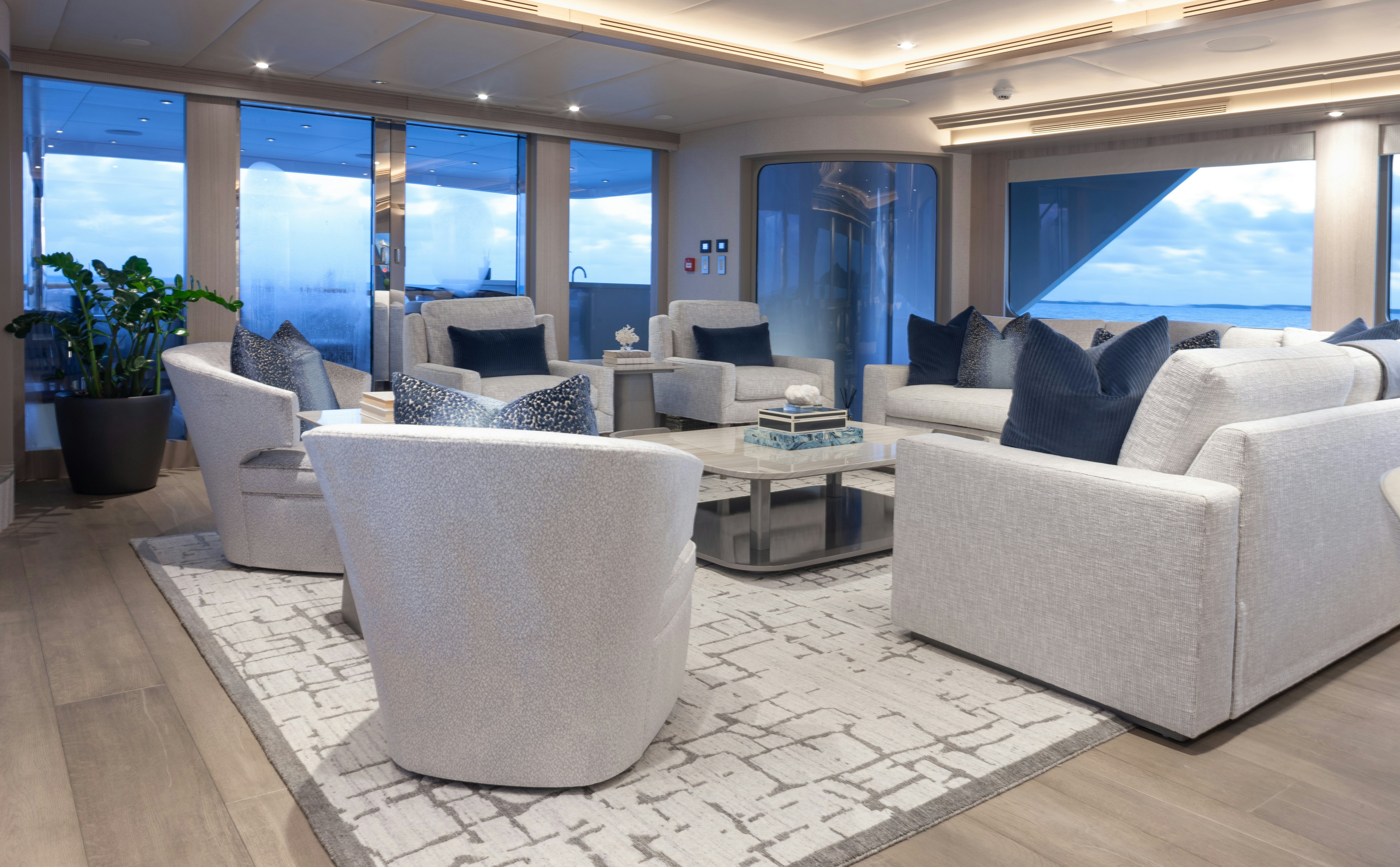 a living room with white furniture aboard NO BAD IDEAS Yacht for Sale