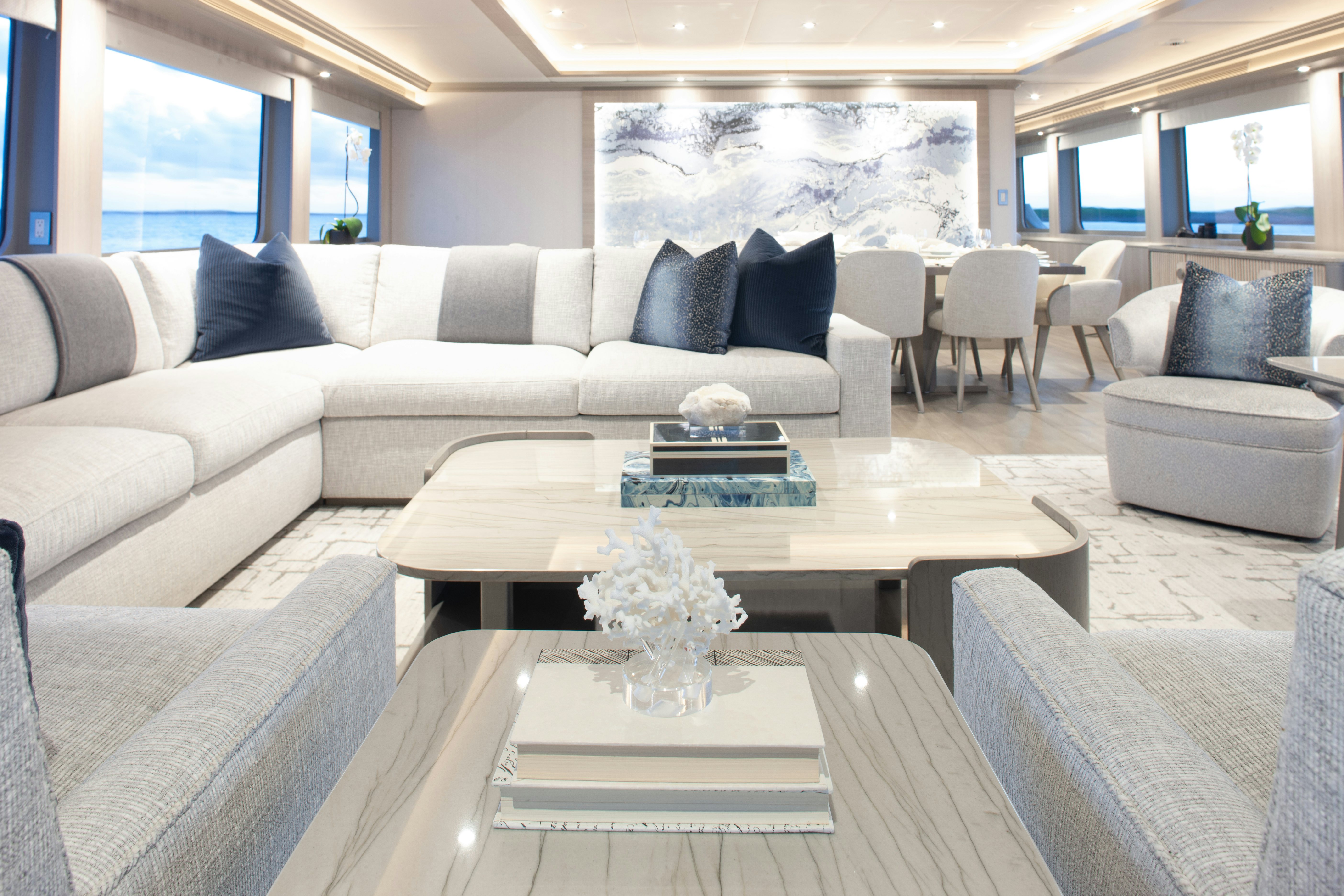 a living room with a white couch and a table aboard NO BAD IDEAS Yacht for Sale