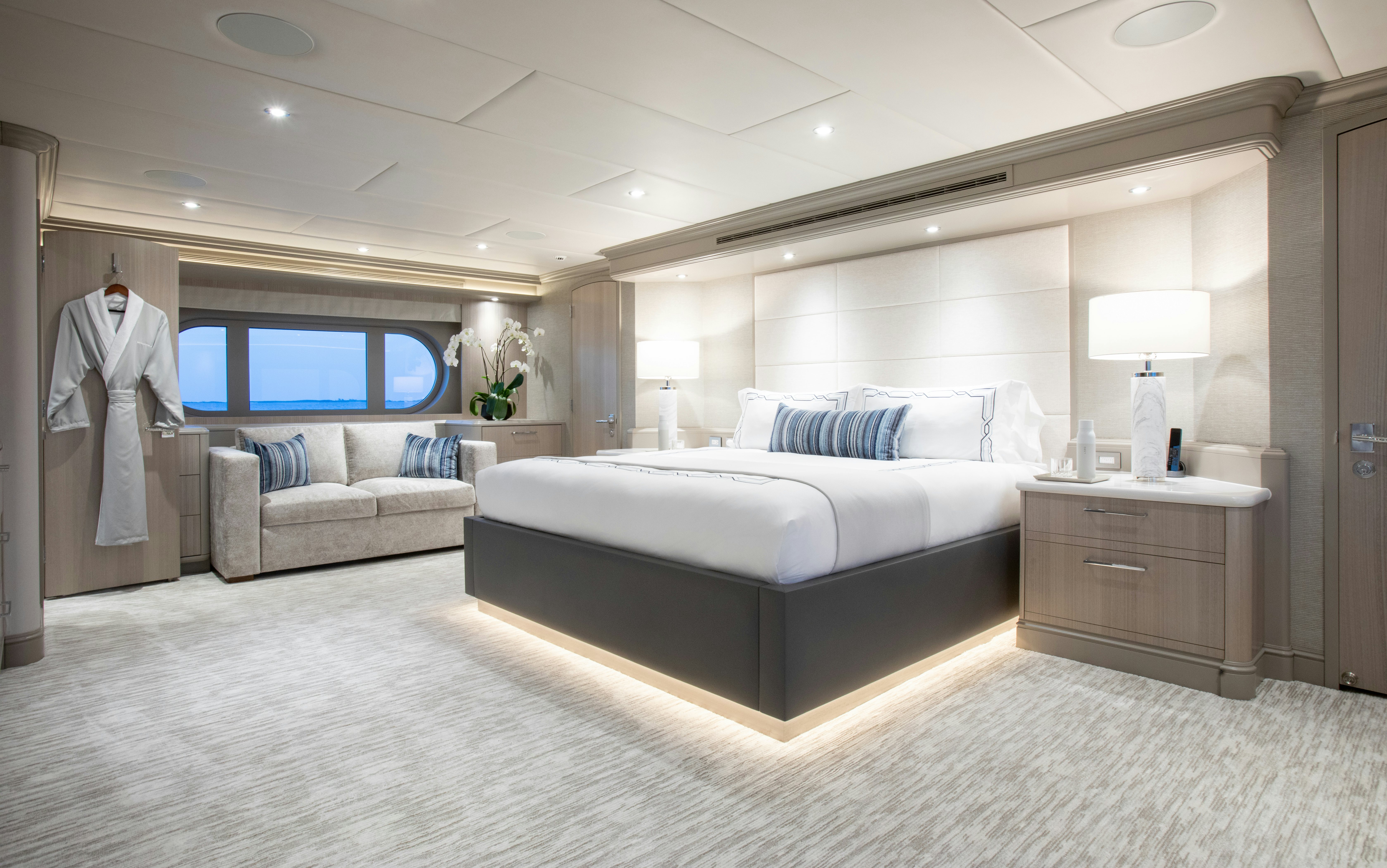 a large white bedroom with a large bed and a large mirror aboard NO BAD IDEAS Yacht for Sale