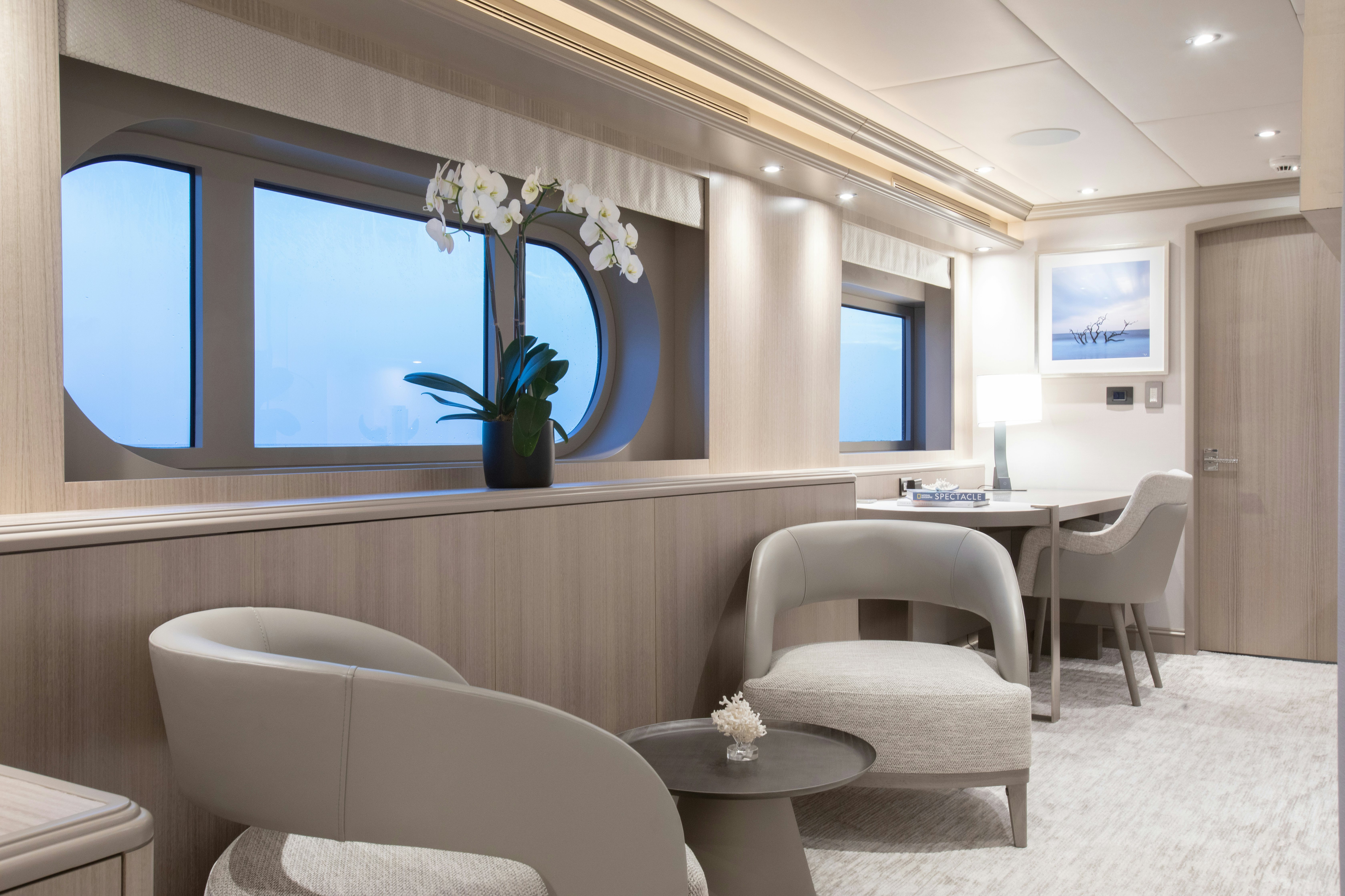 a room with a couch and a table and chairs aboard NO BAD IDEAS Yacht for Sale