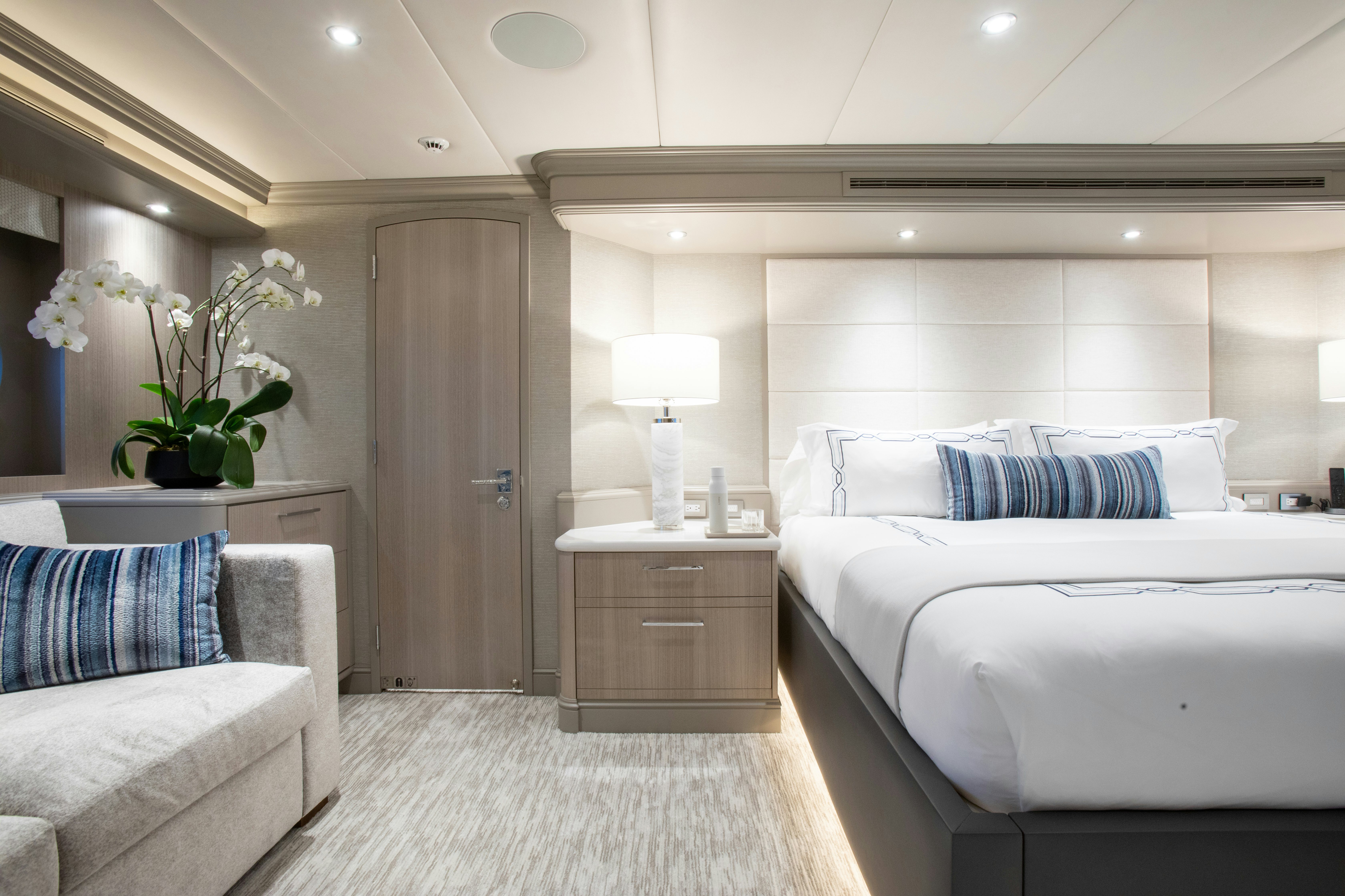 a bedroom with a bed and a desk aboard NO BAD IDEAS Yacht for Sale