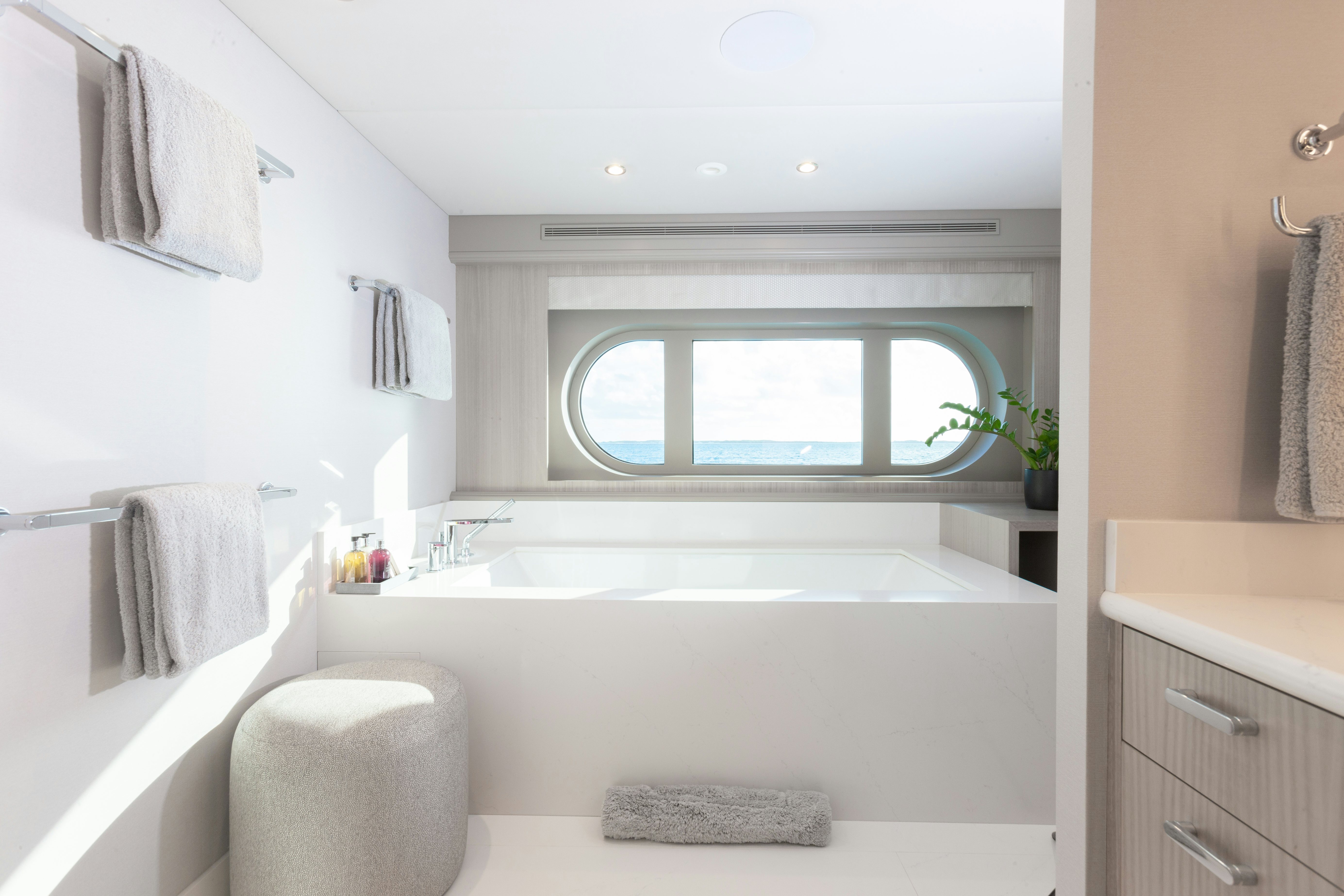 a bathroom with a tub sink and a window aboard NO BAD IDEAS Yacht for Sale