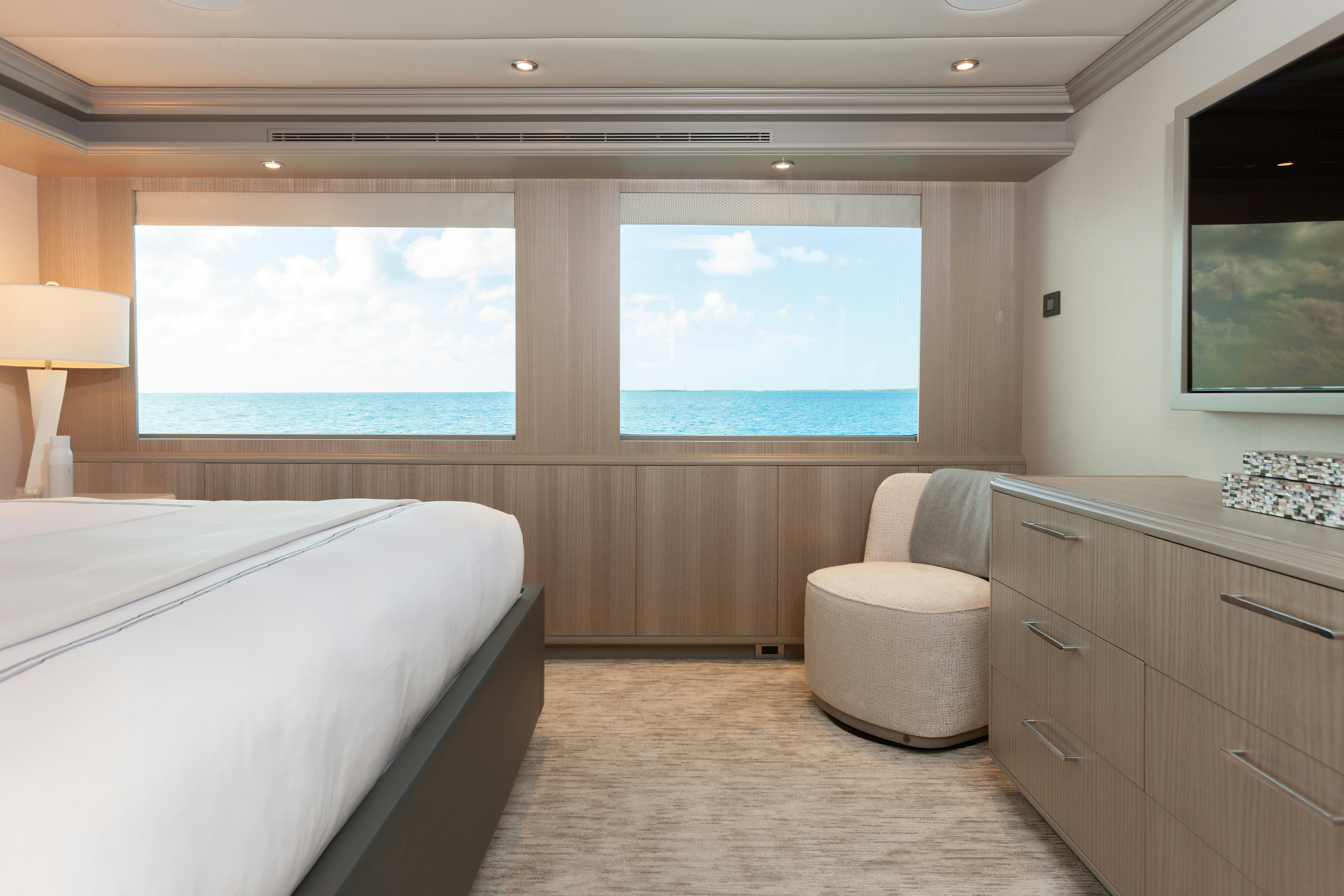 a room with a bed and a window aboard NO BAD IDEAS Yacht for Sale