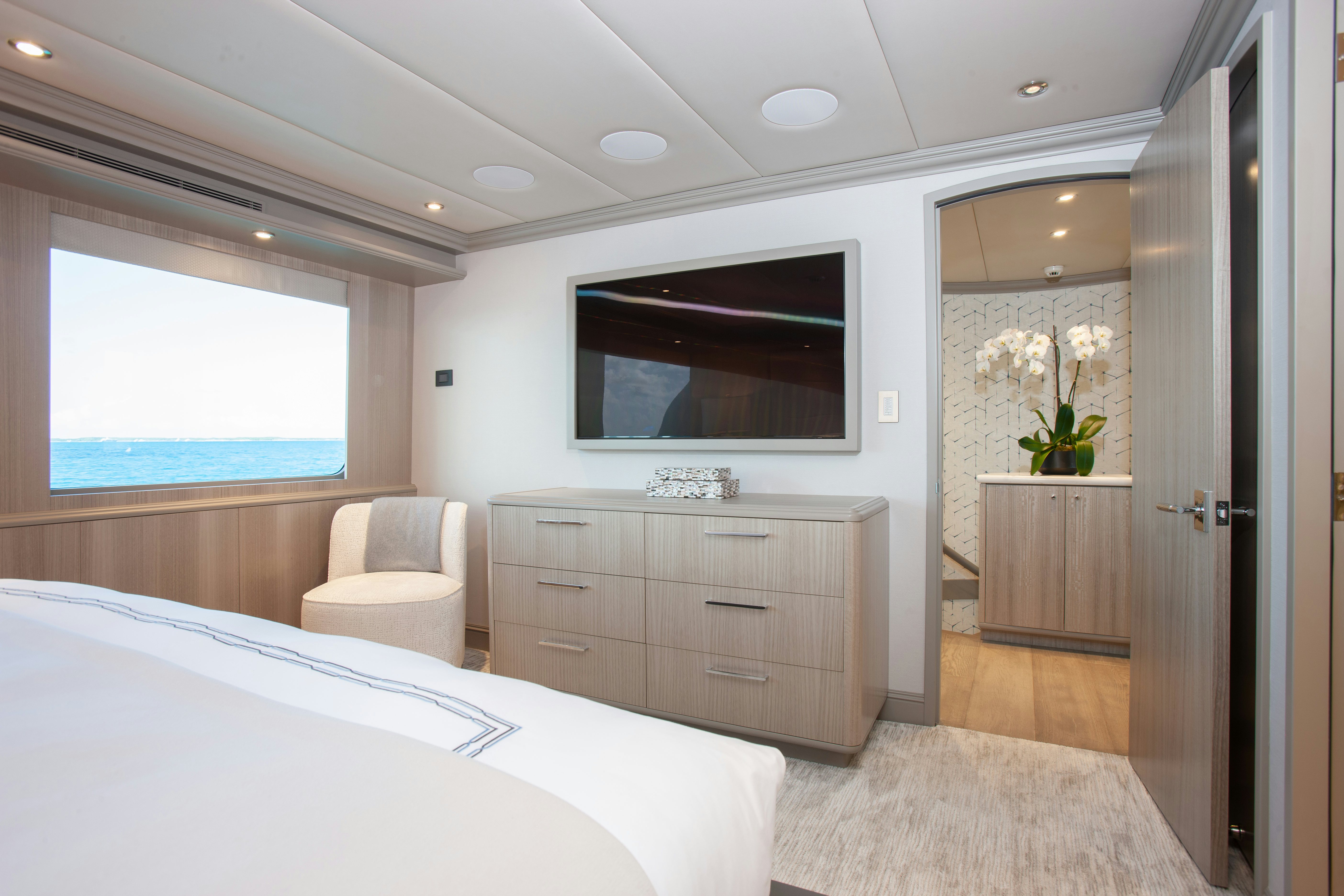 a bedroom with a large bed and a tv aboard NO BAD IDEAS Yacht for Sale