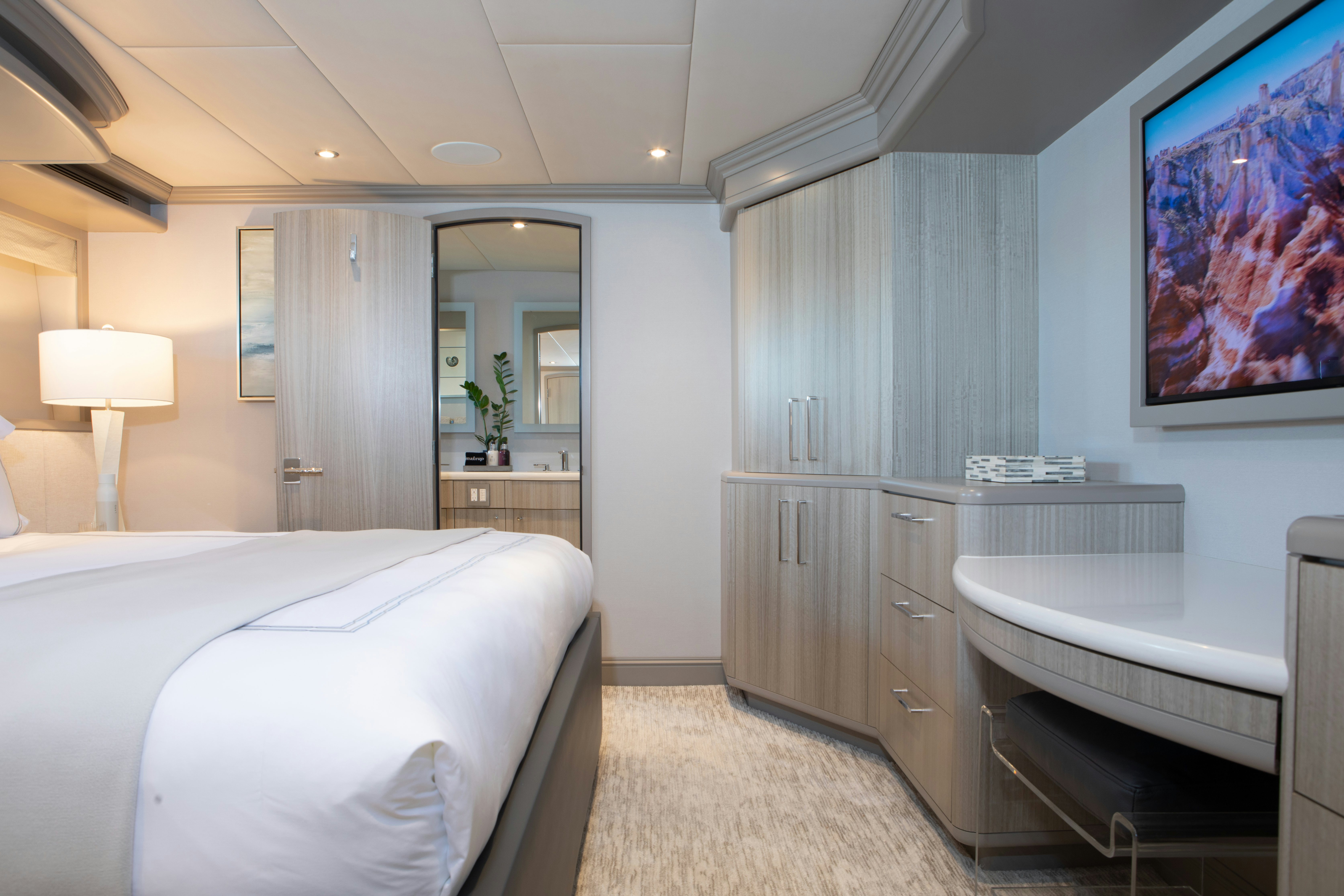 a bedroom with a bed and a desk aboard NO BAD IDEAS Yacht for Sale