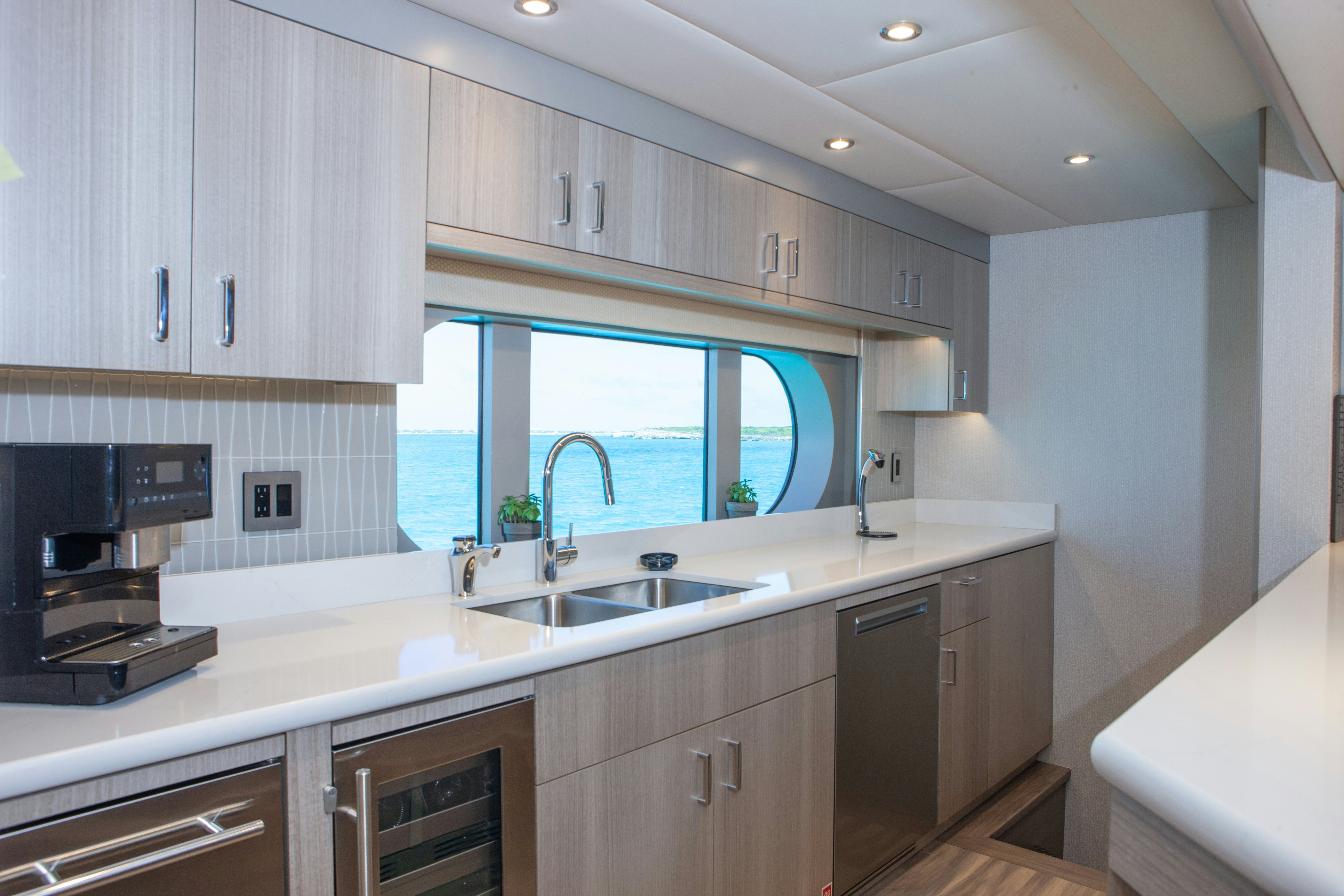 a kitchen with white cabinets aboard NO BAD IDEAS Yacht for Sale