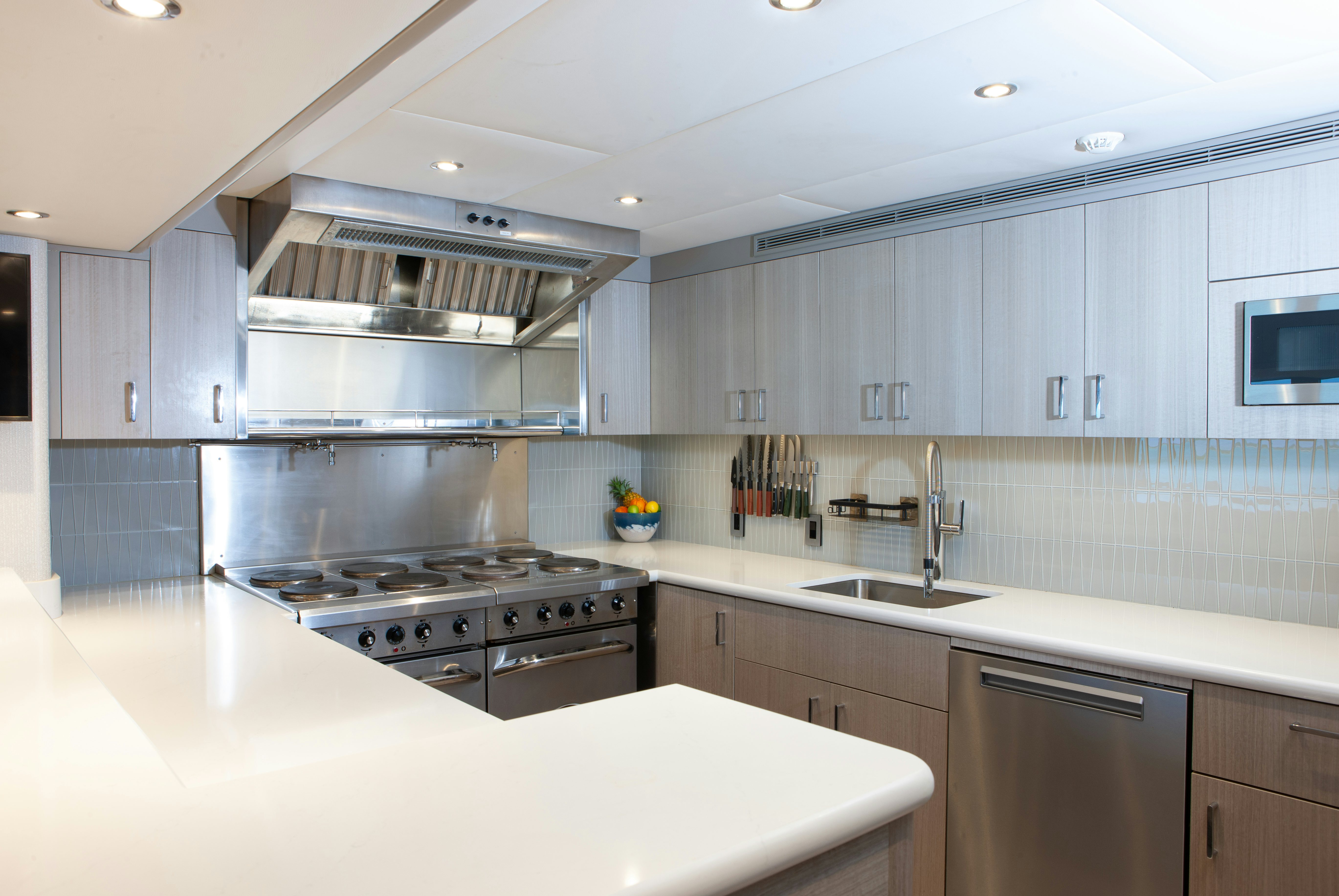 a kitchen with white cabinets aboard NO BAD IDEAS Yacht for Sale
