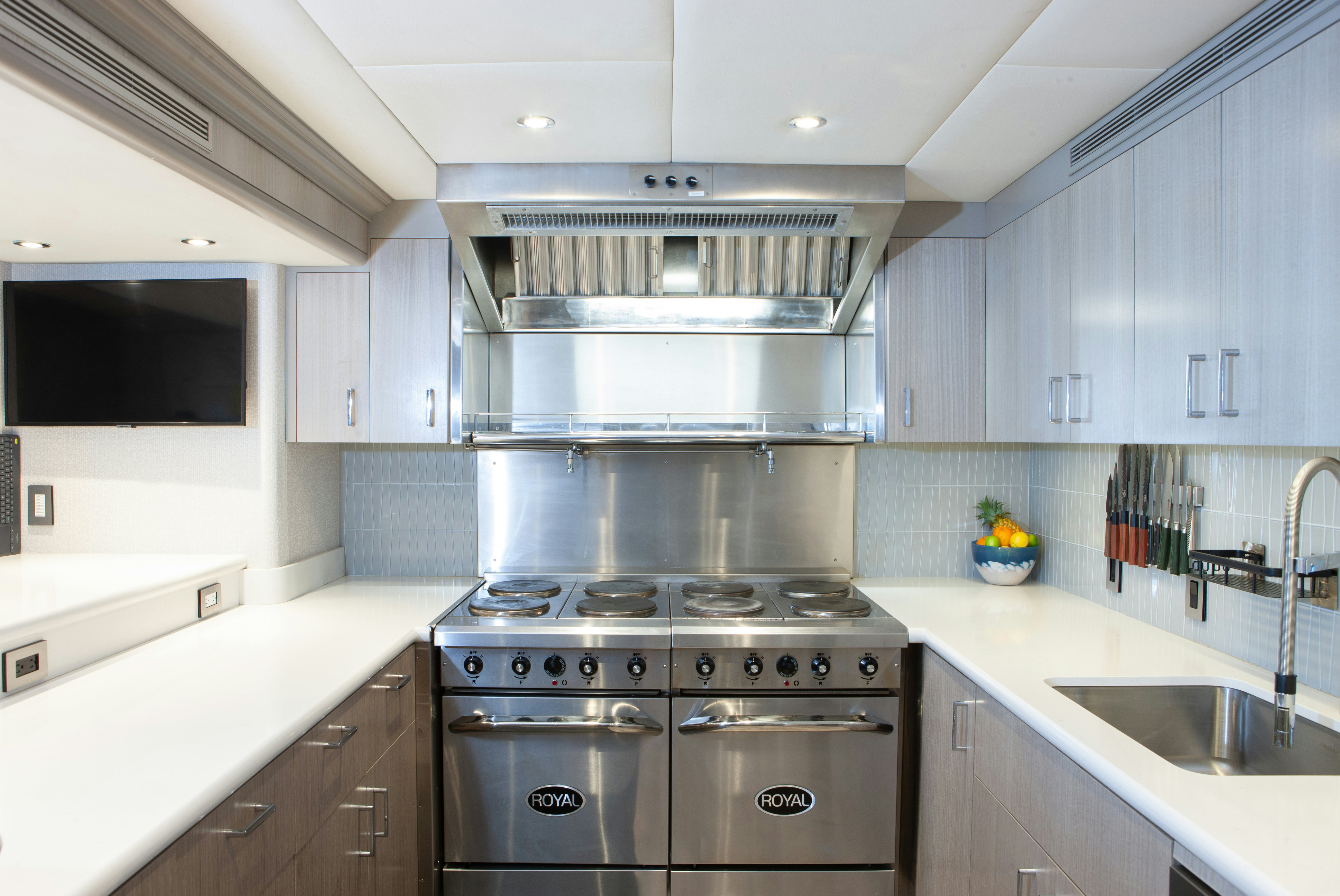 a kitchen with white cabinets aboard NO BAD IDEAS Yacht for Sale