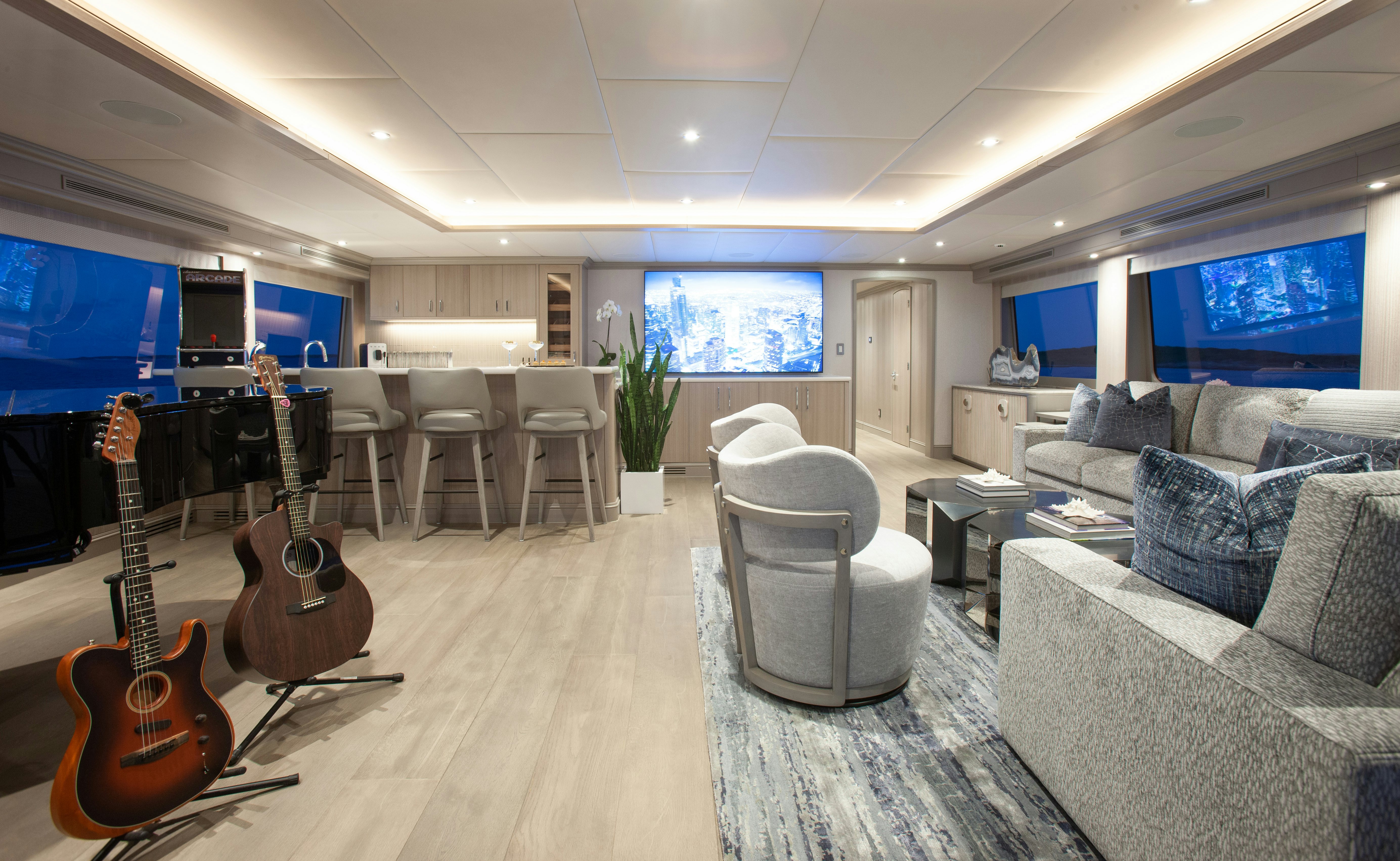 a room with a couch and a guitar aboard NO BAD IDEAS Yacht for Sale