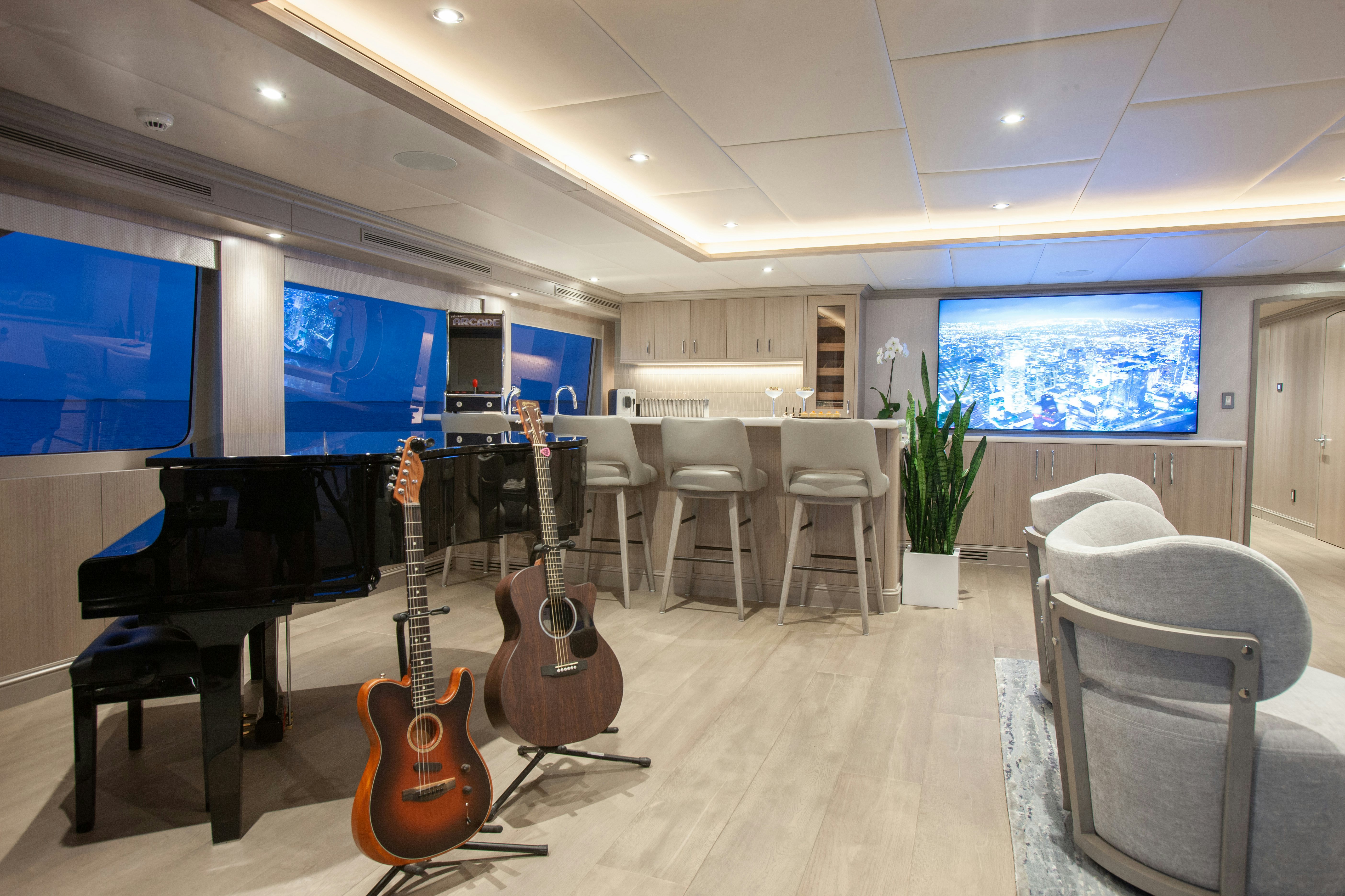 a room with a tv and a guitar aboard NO BAD IDEAS Yacht for Sale