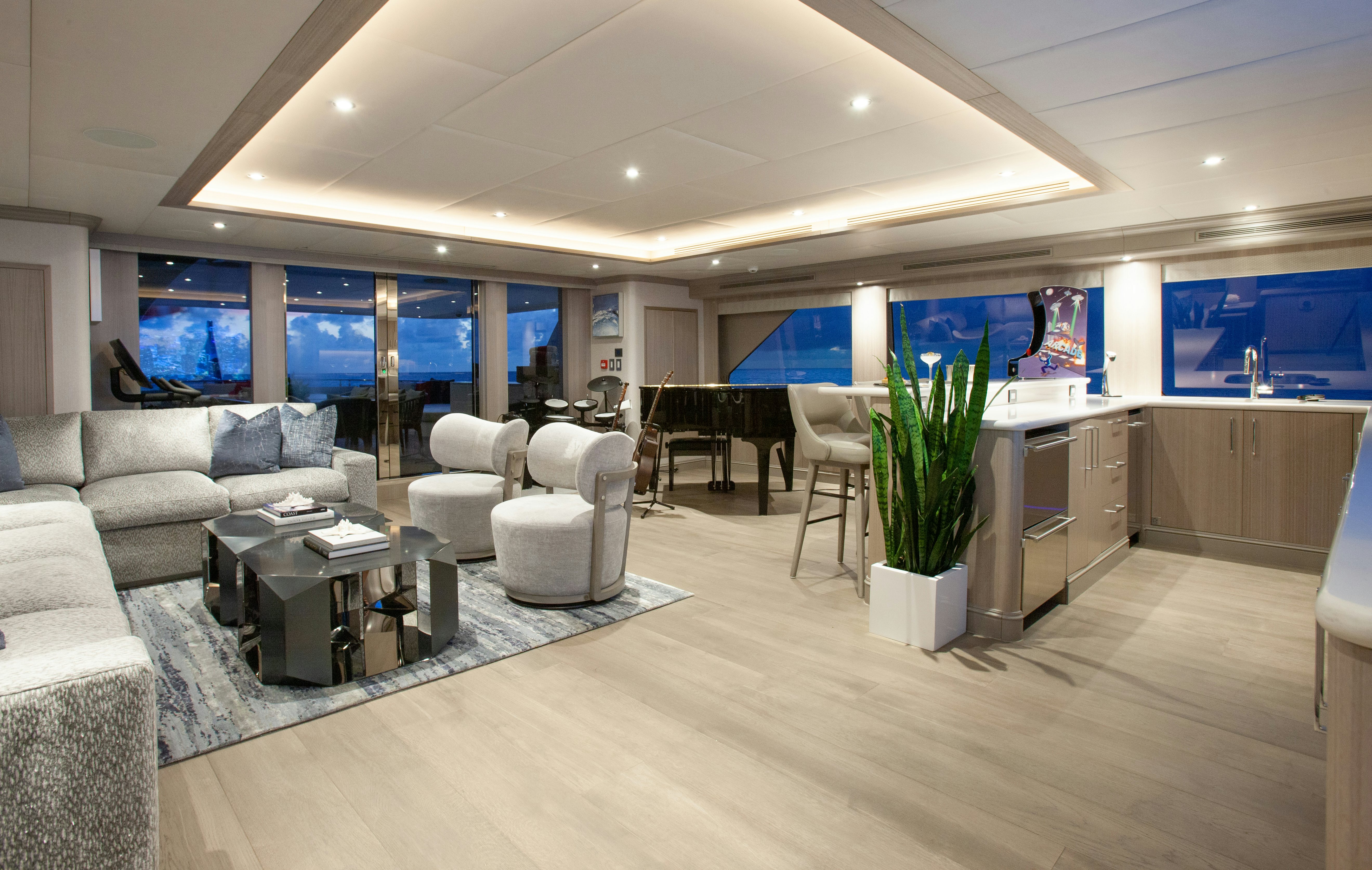 a large room with a couch and a table and a tv aboard NO BAD IDEAS Yacht for Sale