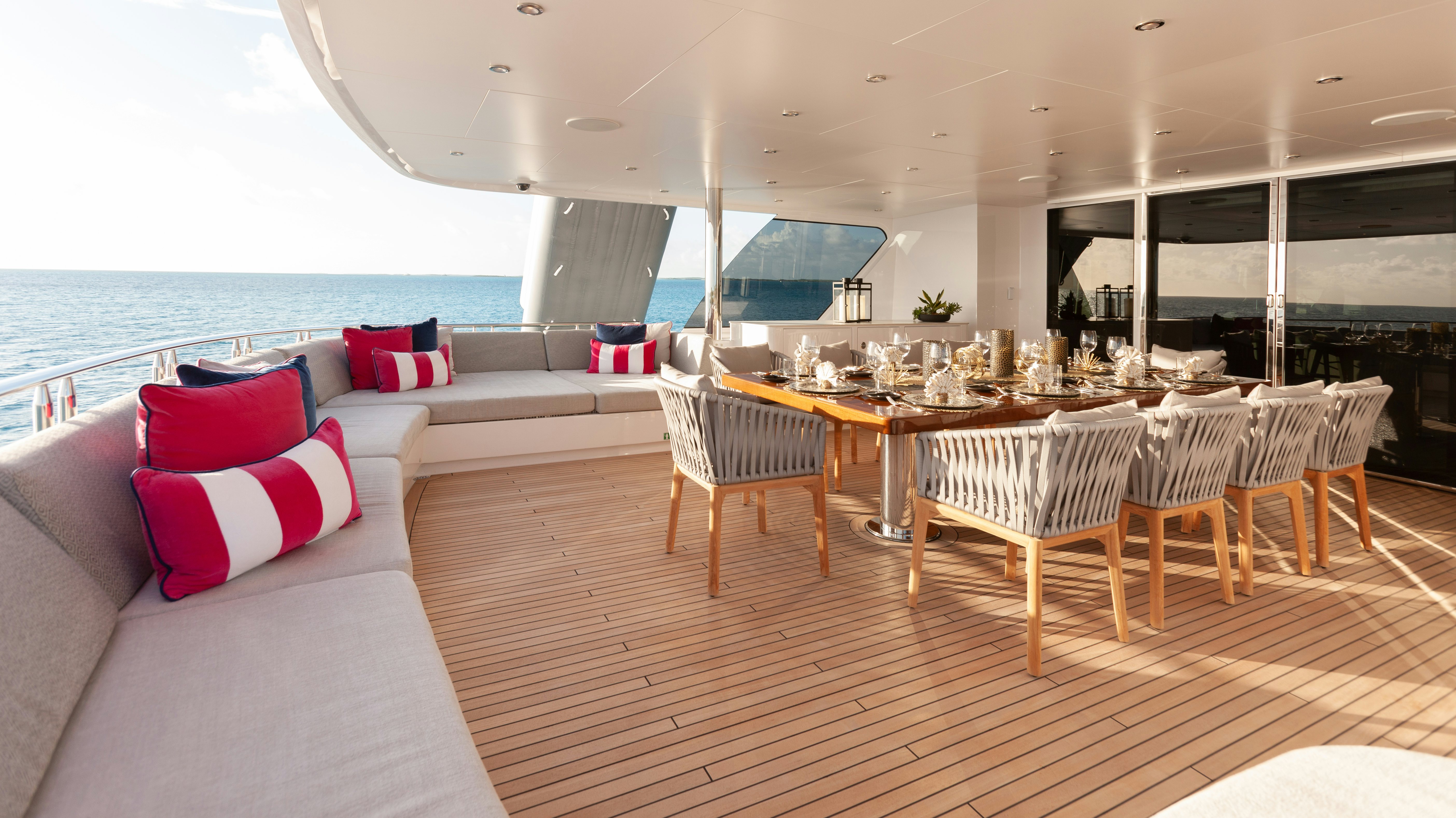 a room with a bed and a table and chairs aboard NO BAD IDEAS Yacht for Sale