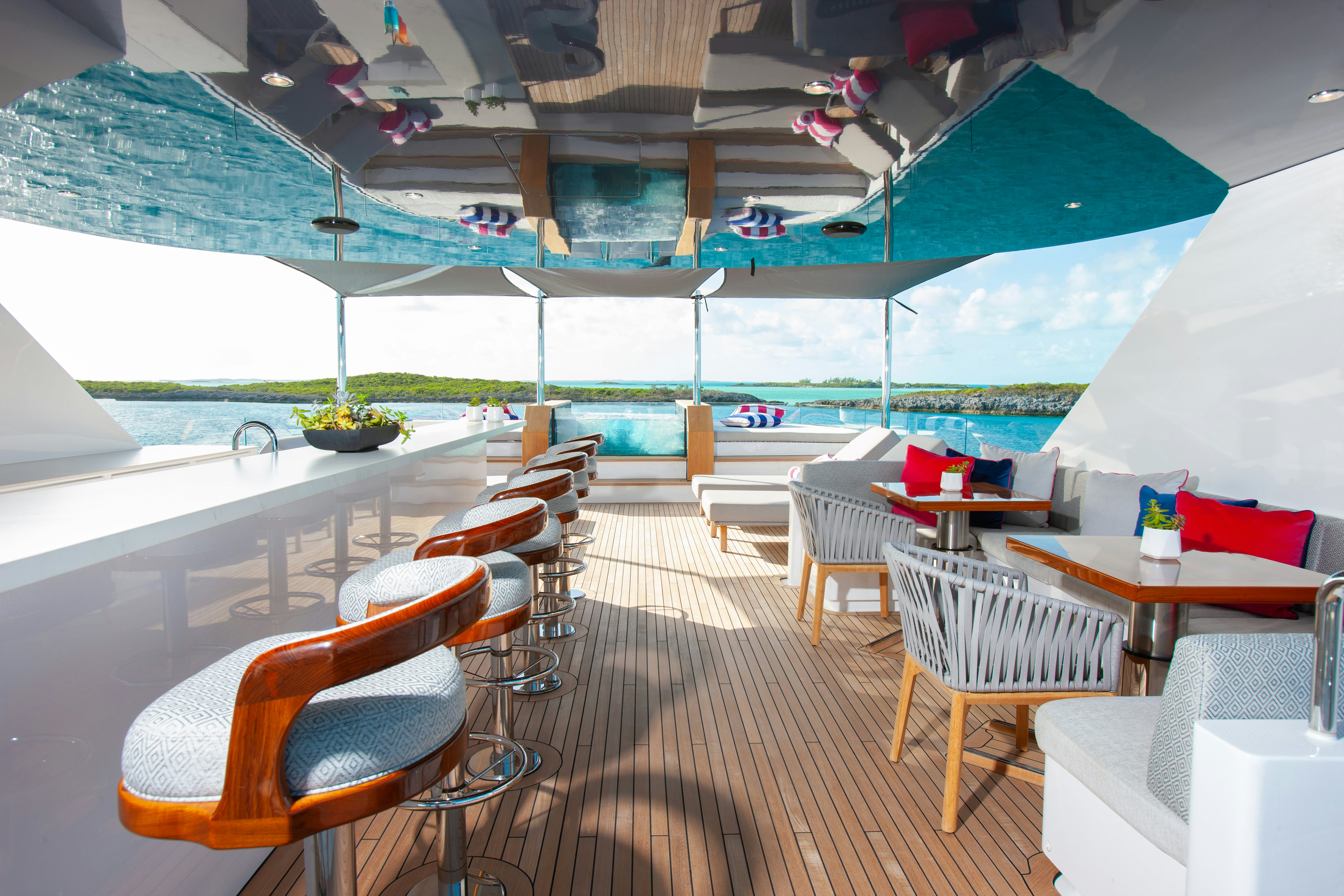 a room with tables and chairs aboard NO BAD IDEAS Yacht for Sale