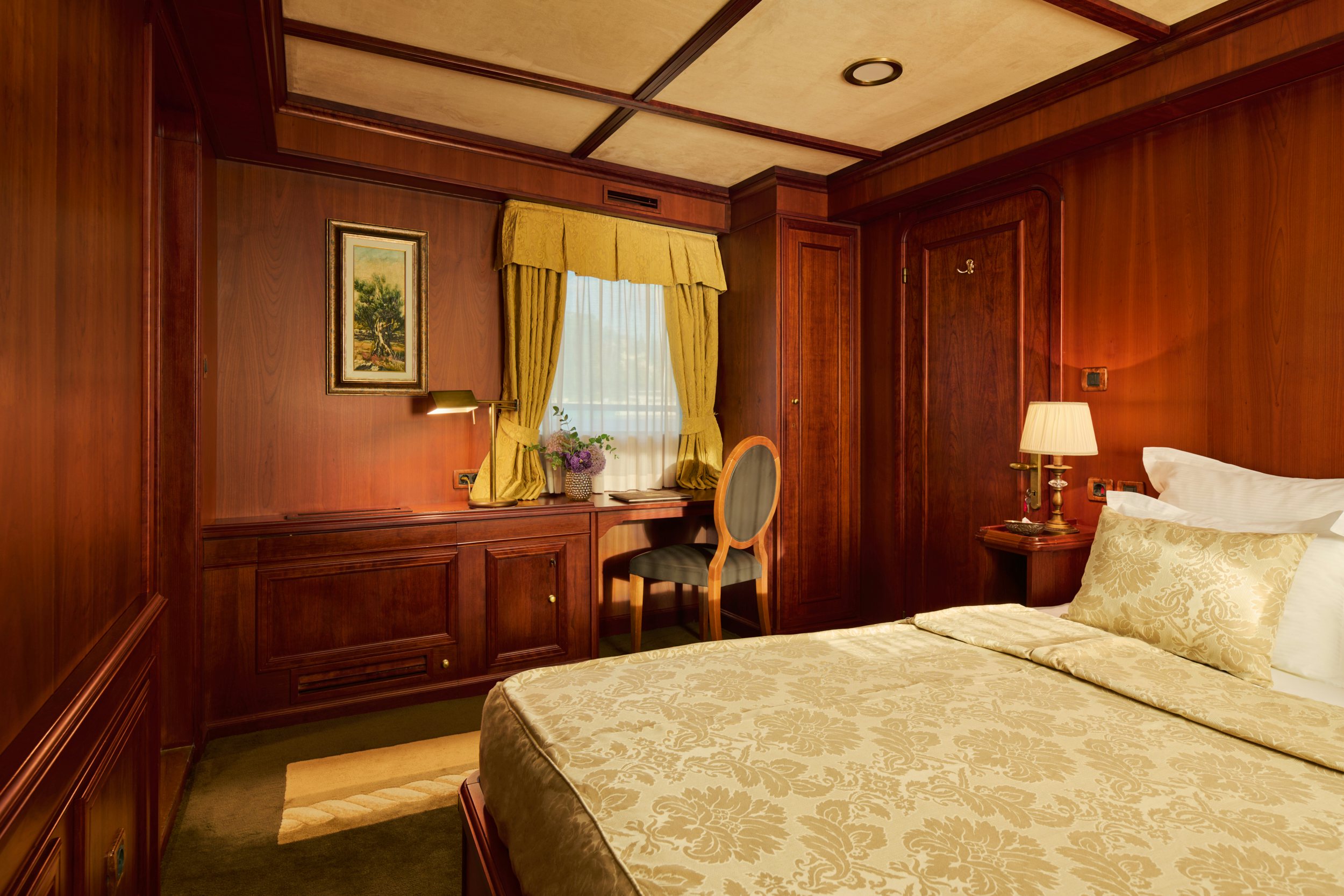 a bedroom with a bed and a chair aboard SEAGULL II Yacht for Charter