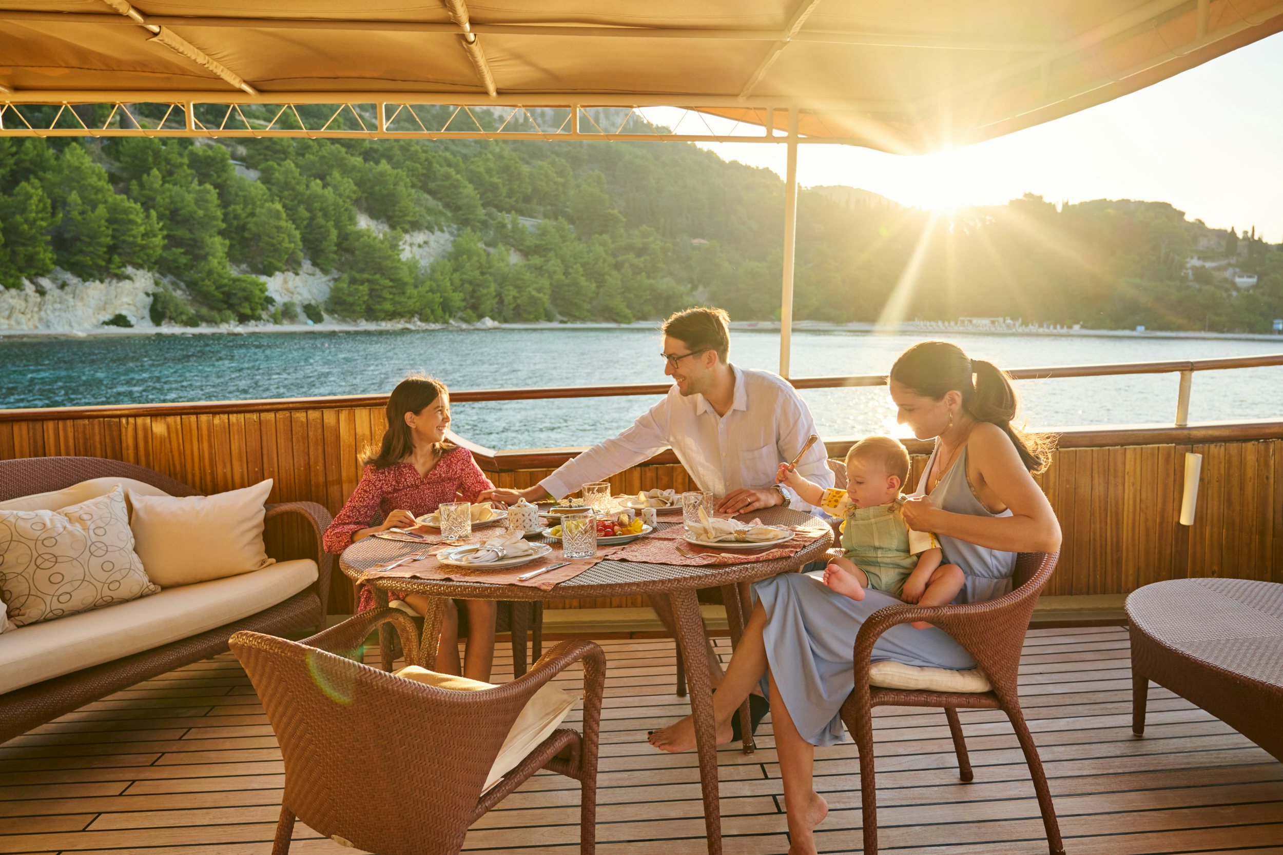 a family sits around a table aboard SEAGULL II Yacht for Charter