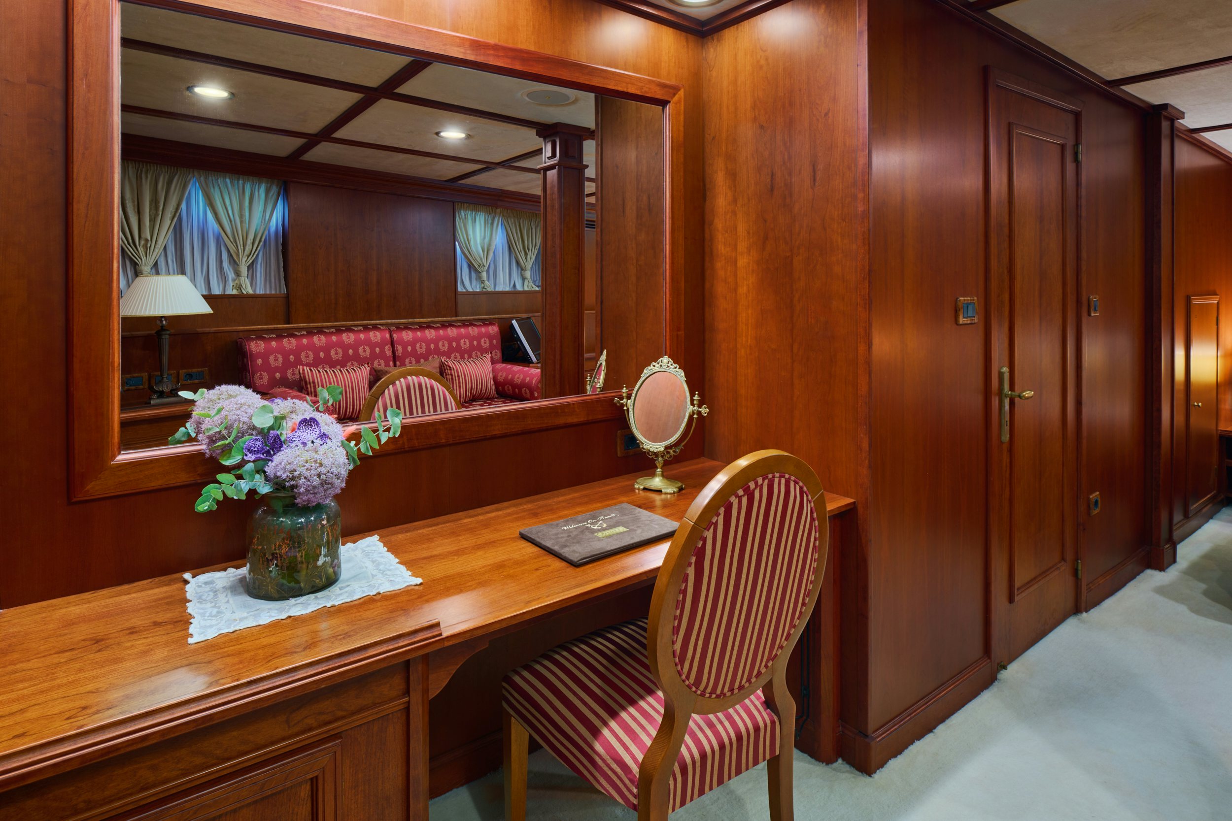 a table with a chair and a vase of flowers on it aboard SEAGULL II Yacht for Charter