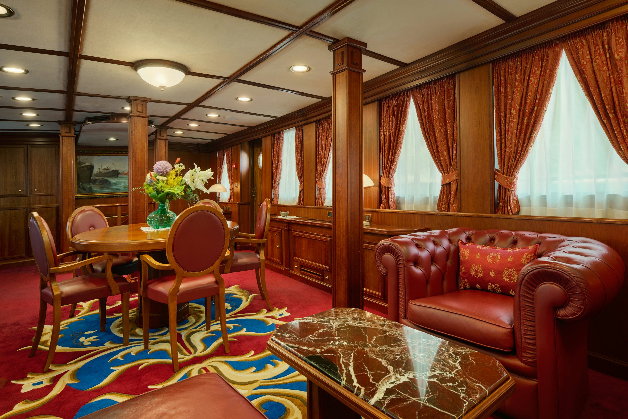 a living room with a table and chairs aboard SEAGULL II Yacht for Charter