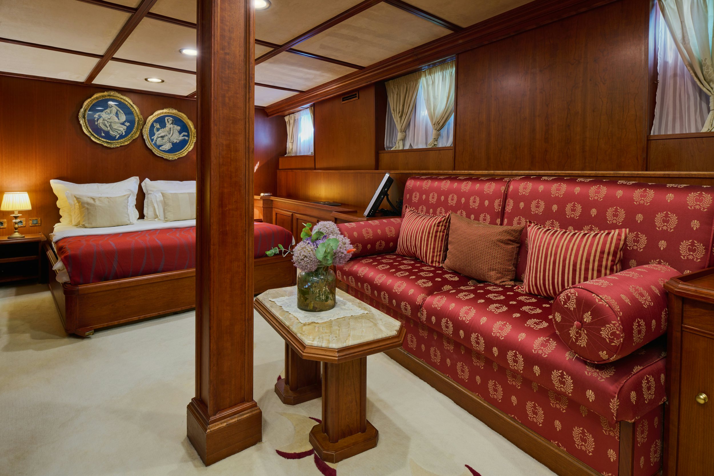 a living room with a red couch aboard SEAGULL II Yacht for Charter