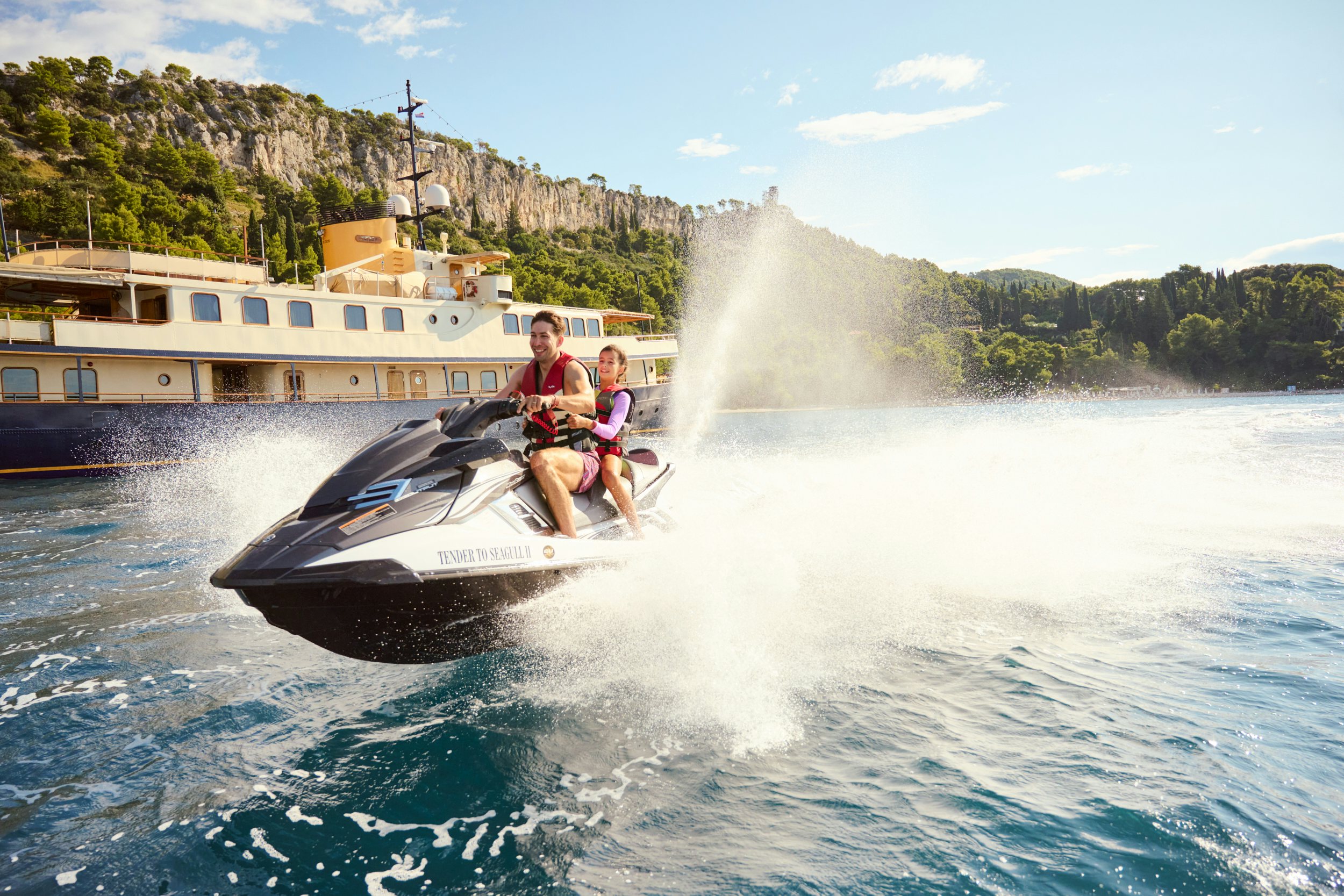 a couple of people on a speed boat in the water aboard SEAGULL II Yacht for Charter