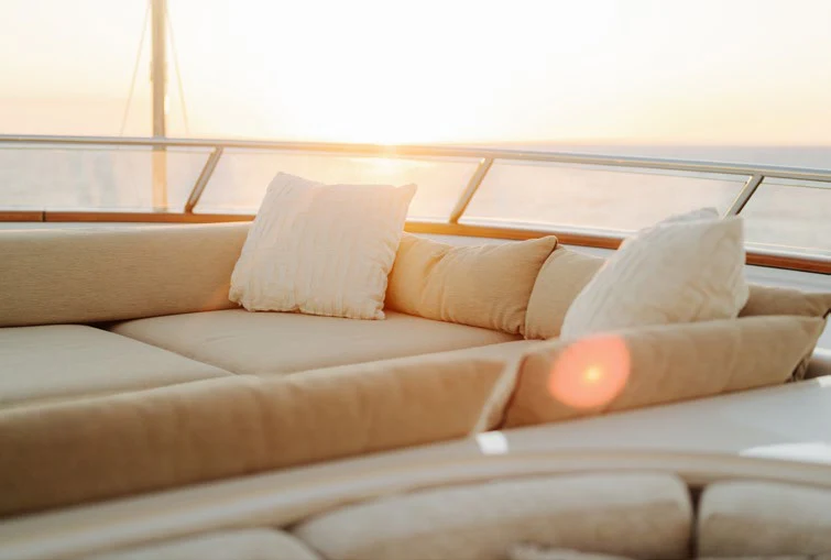a couch with pillows aboard SOLACE Yacht for Charter