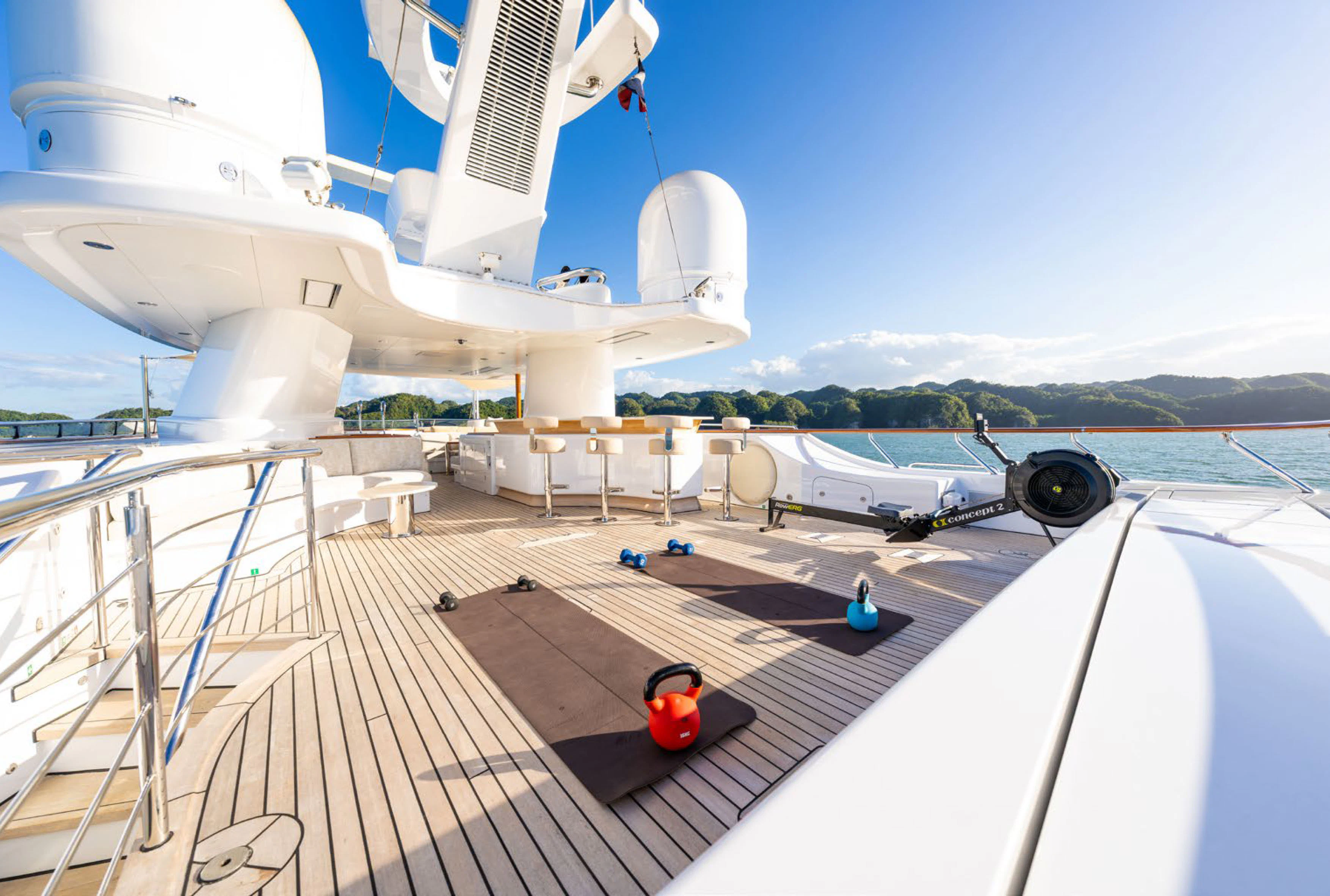 a deck with a couple of white boats on it and a red object on the deck aboard SOLACE Yacht for Charter