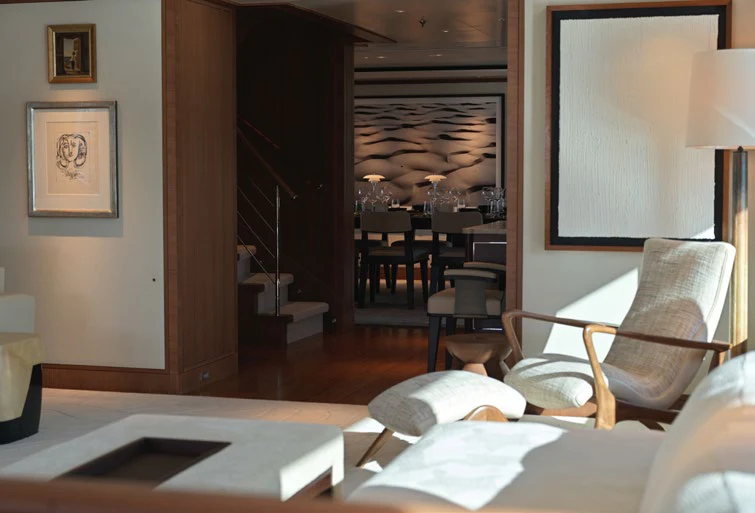 a hotel room with a bed and a desk aboard SOLACE Yacht for Charter