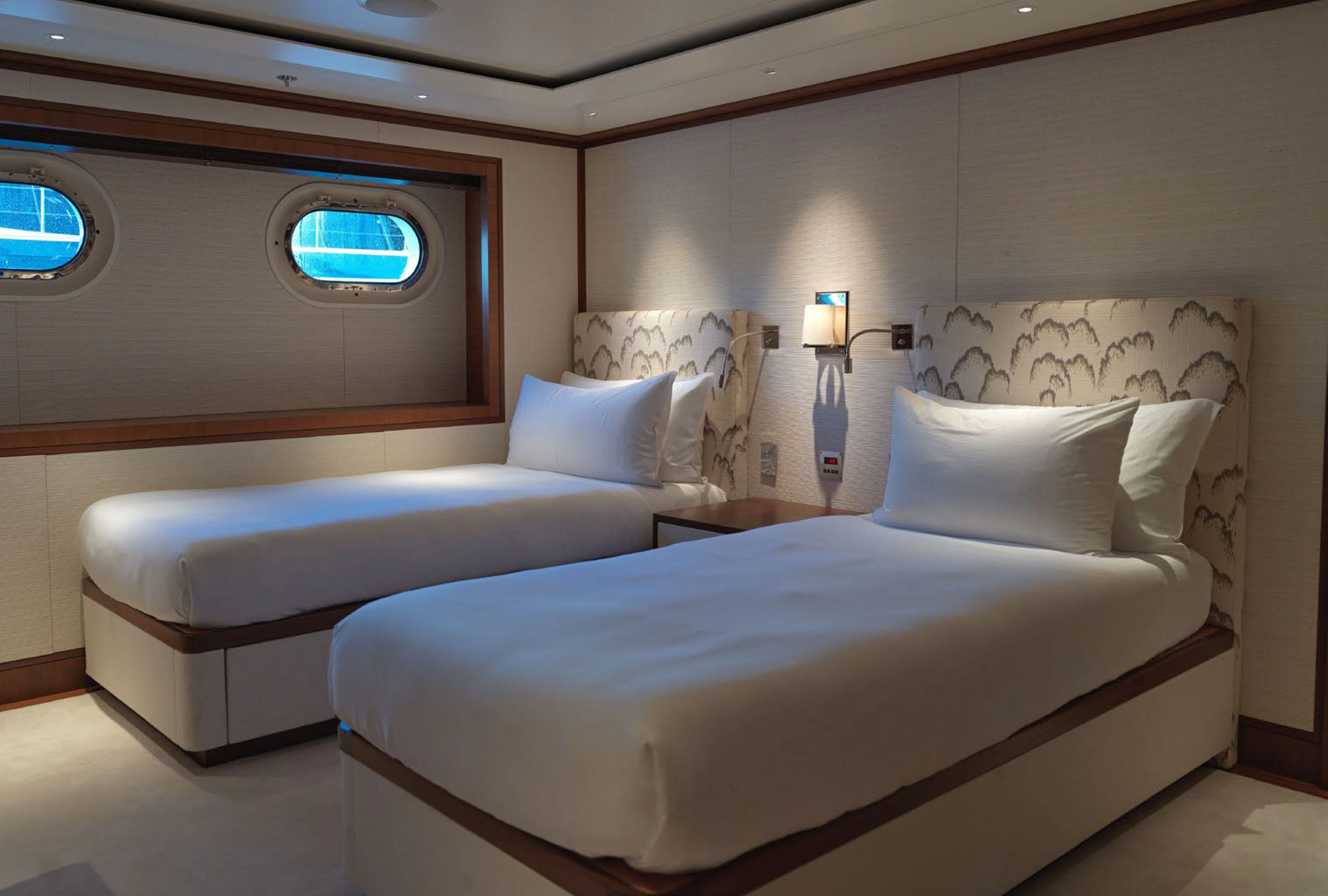 a couple of beds in a room aboard SOLACE Yacht for Charter
