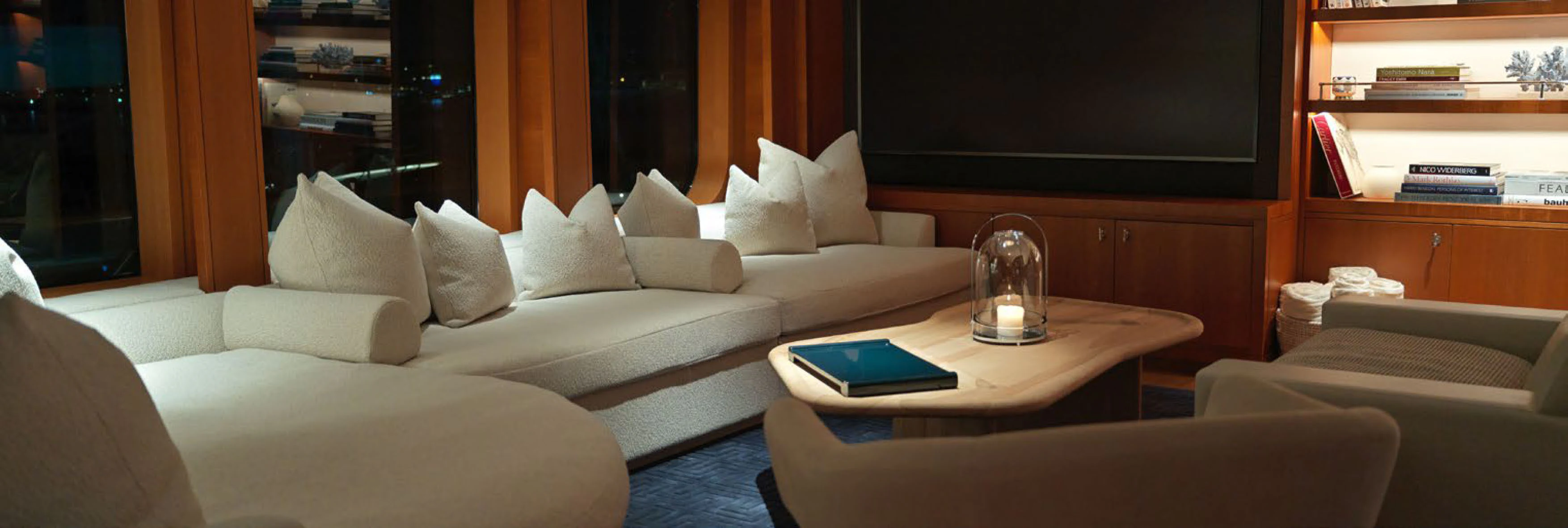 a living room with a glass of water on the coffee table aboard SOLACE Yacht for Charter