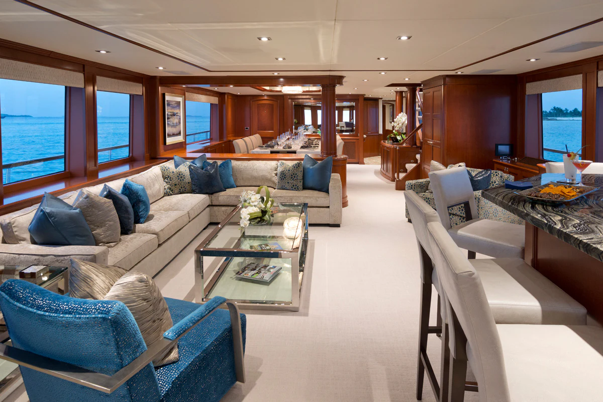 a living room with a couch and a coffee table aboard FORE ACES Yacht for Sale