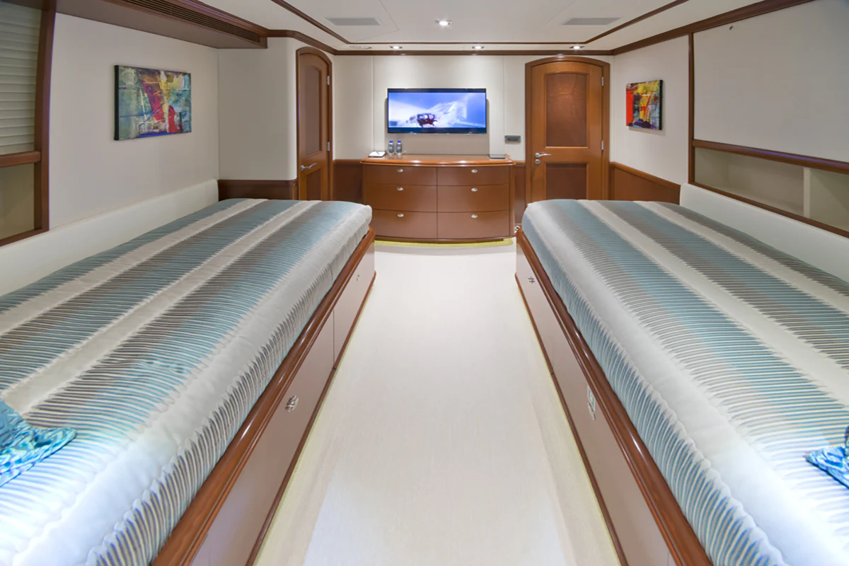 a room with a bed and a television aboard FORE ACES Yacht for Sale