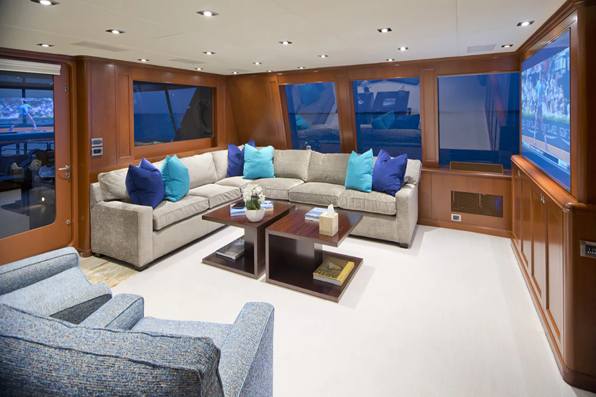 a living room with a couch and a tv aboard FORE ACES Yacht for Sale