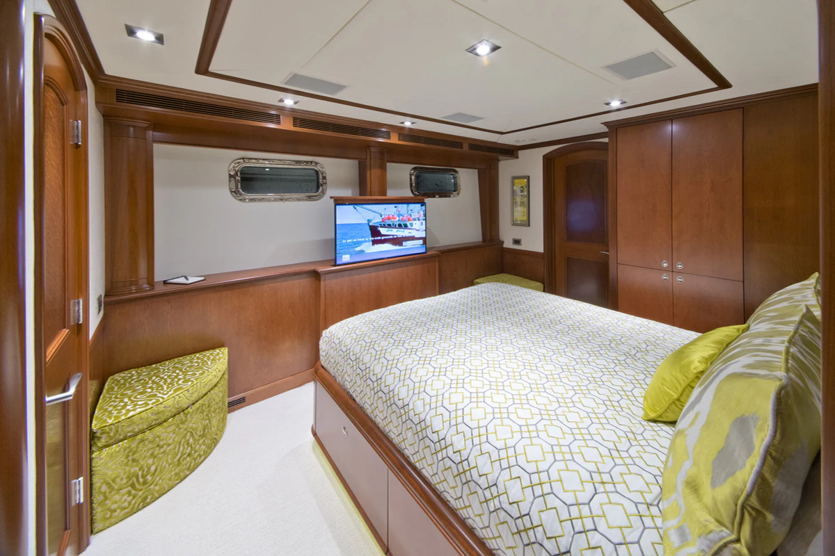 a room with a bed and a television aboard FORE ACES Yacht for Sale
