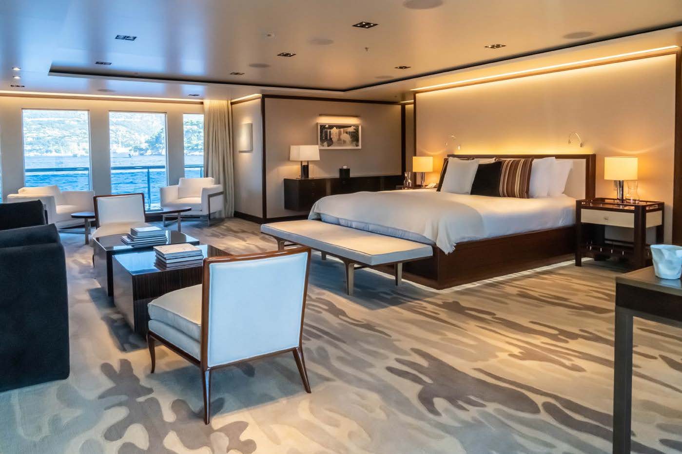 a hotel room with a bed and desk aboard PLANET NINE Yacht for Sale