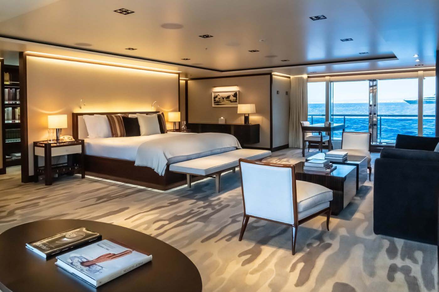 a hotel room with a bed and a table aboard PLANET NINE Yacht for Sale