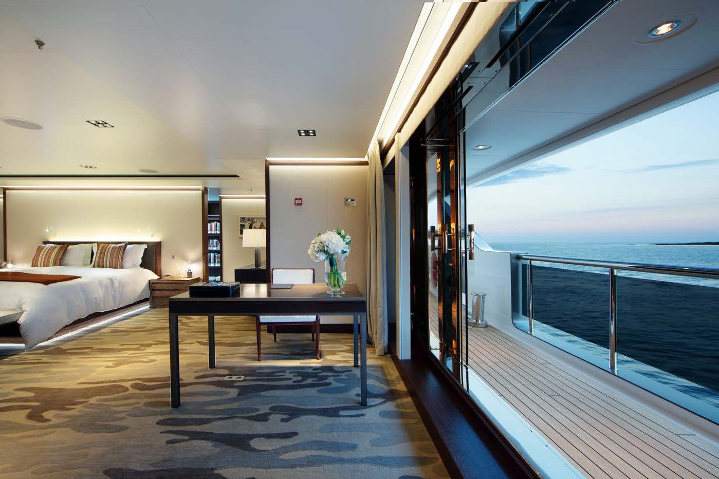 a room with a table and a bed aboard PLANET NINE Yacht for Sale