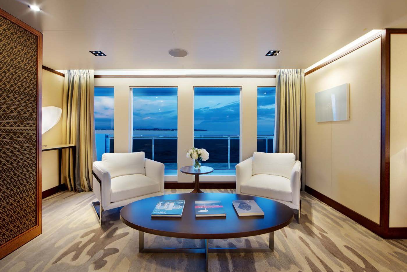 a living room with a table and chairs aboard PLANET NINE Yacht for Sale