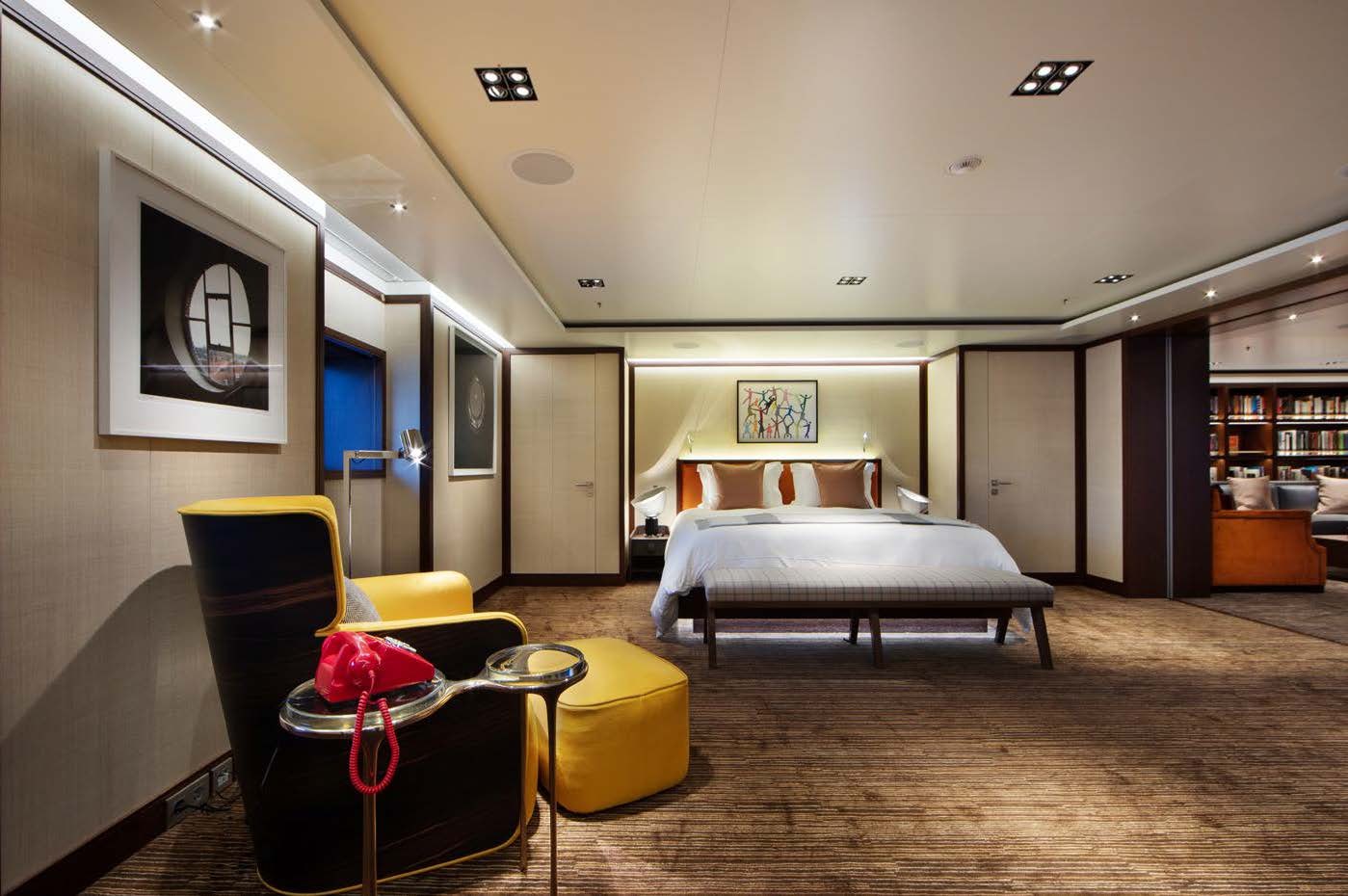 a bedroom with a bed and a chair aboard PLANET NINE Yacht for Sale