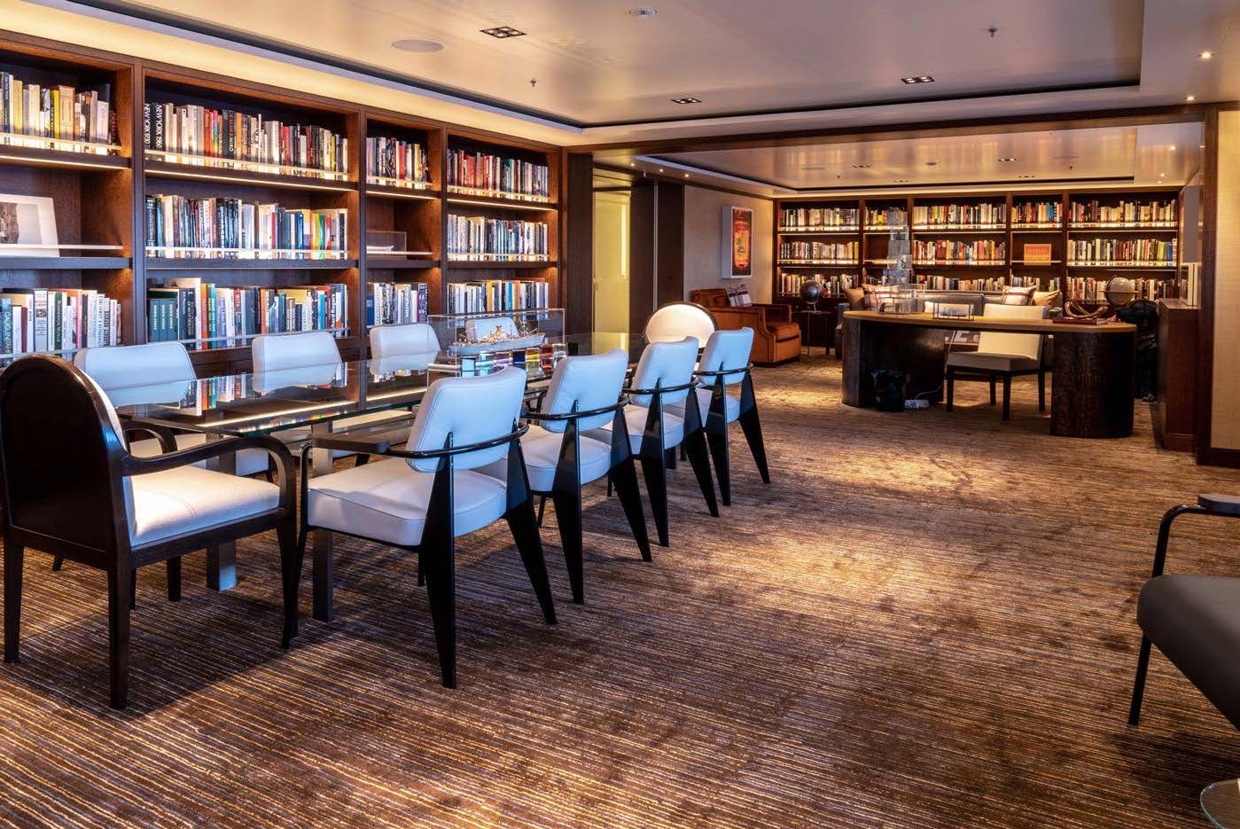 a library with a large table and chairs aboard PLANET NINE Yacht for Sale