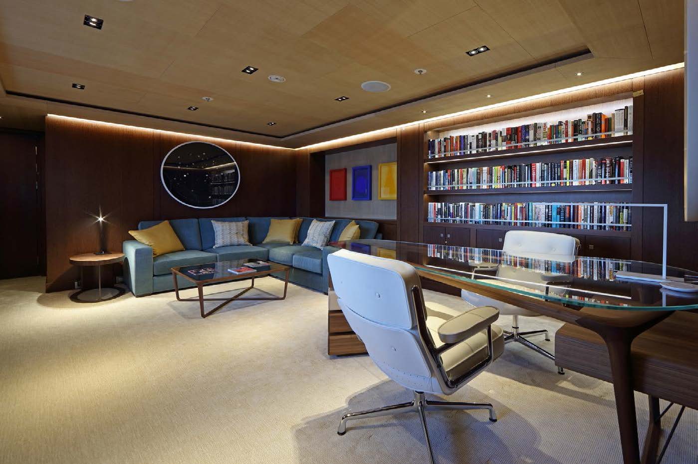 a room with a couch and a table and a bookcase aboard PLANET NINE Yacht for Sale