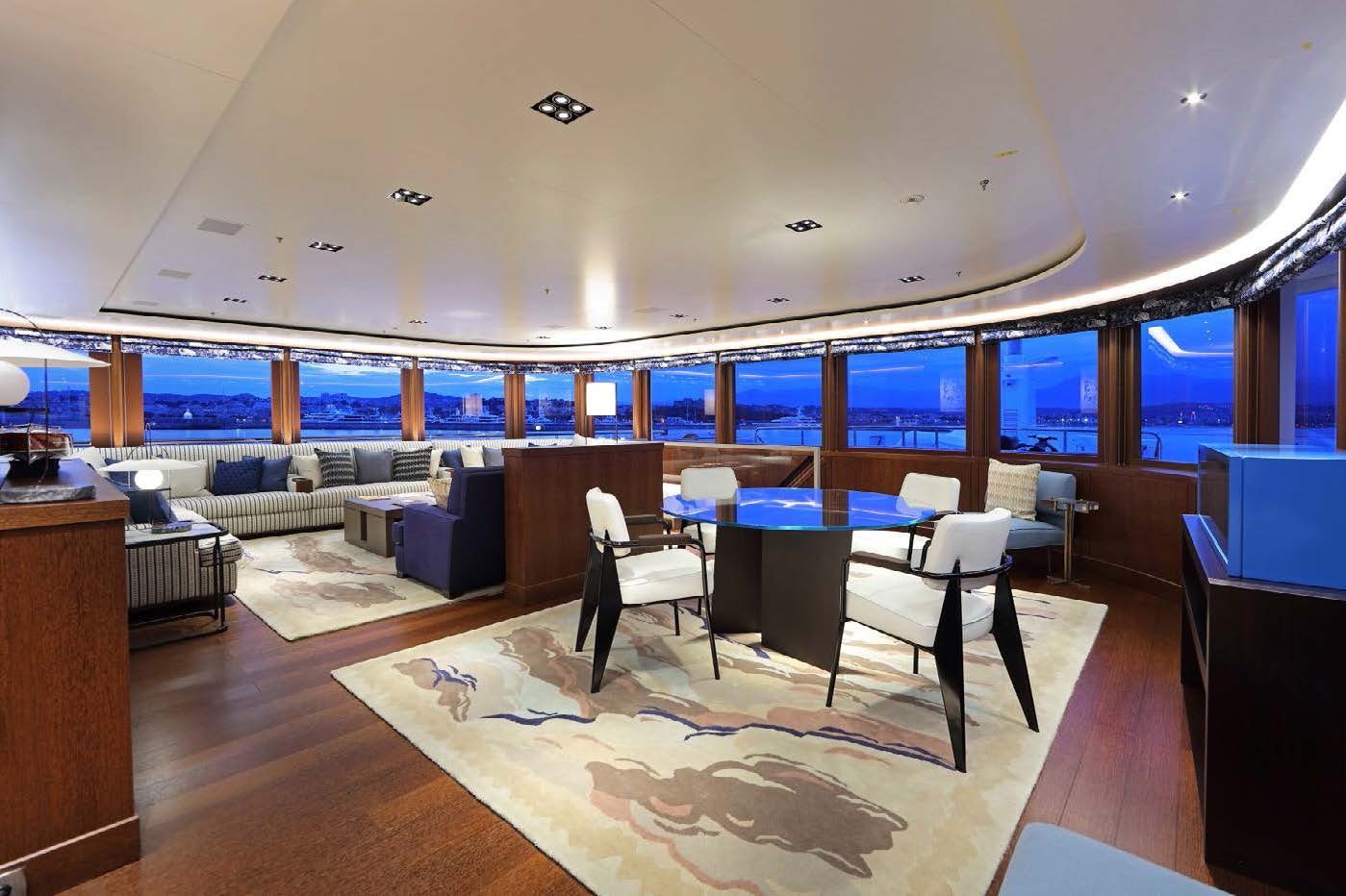 a room with a table and chairs aboard PLANET NINE Yacht for Sale