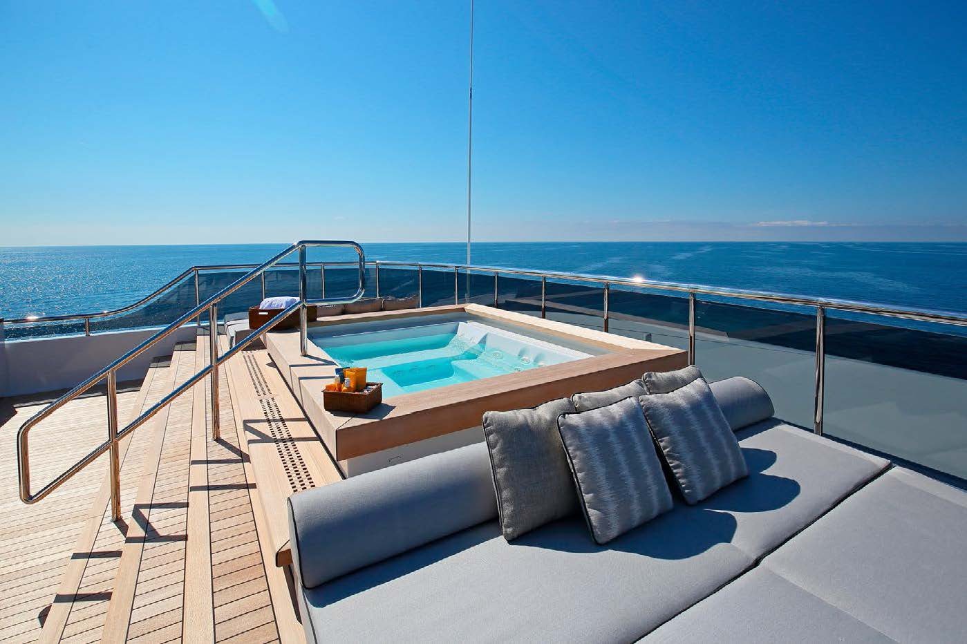 a balcony with a pool and a view of the ocean aboard PLANET NINE Yacht for Sale