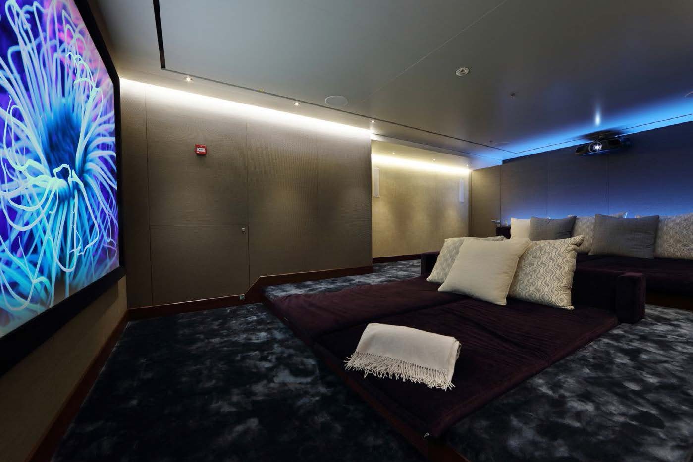 a room with a bed and a painting on the wall aboard PLANET NINE Yacht for Sale